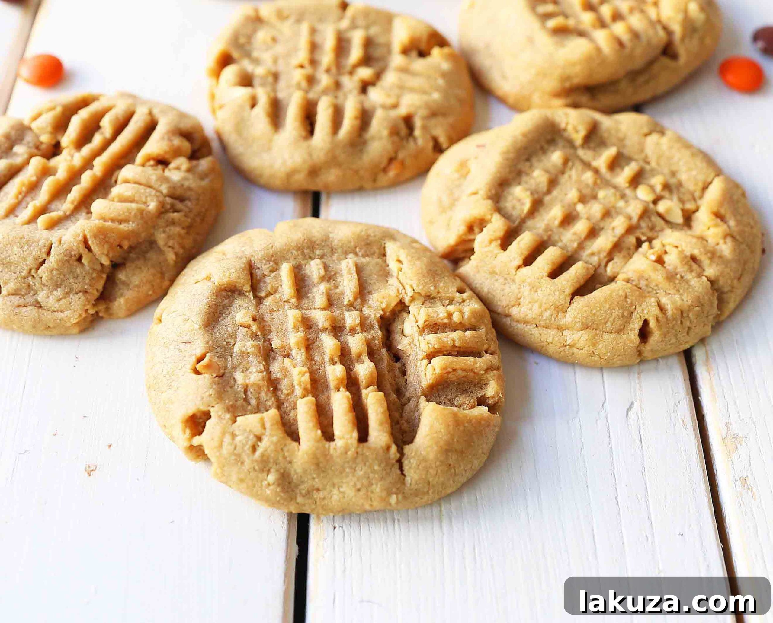 A plate of delicious homemade peanut butter cookies, ready to be enjoyed with a glass of cold milk.