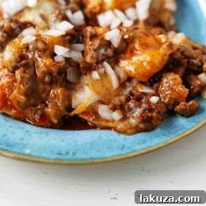Chile con Carne Enchiladas. Authentic Tex-Mex Beef Enchiladas Recipe. Cheese Enchiladas topped with homemade chile con carne. The best chile con carne enchiladas recipe! #chiliconcarne #texmex #texmexenchiladas #enchiladas #mexicanfood