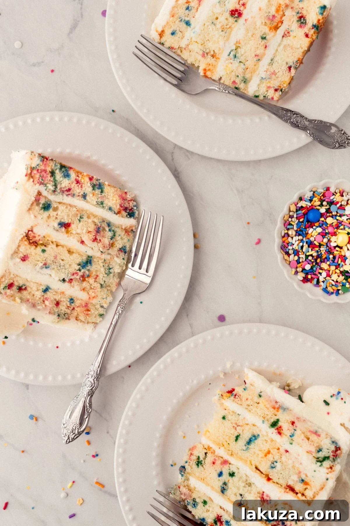 Joyful Sprinkle Celebration 14 Several neatly cut pieces of Funfetti birthday cake, each revealing its colorful sprinkle interior and creamy frosting, elegantly arranged on a serving platter.