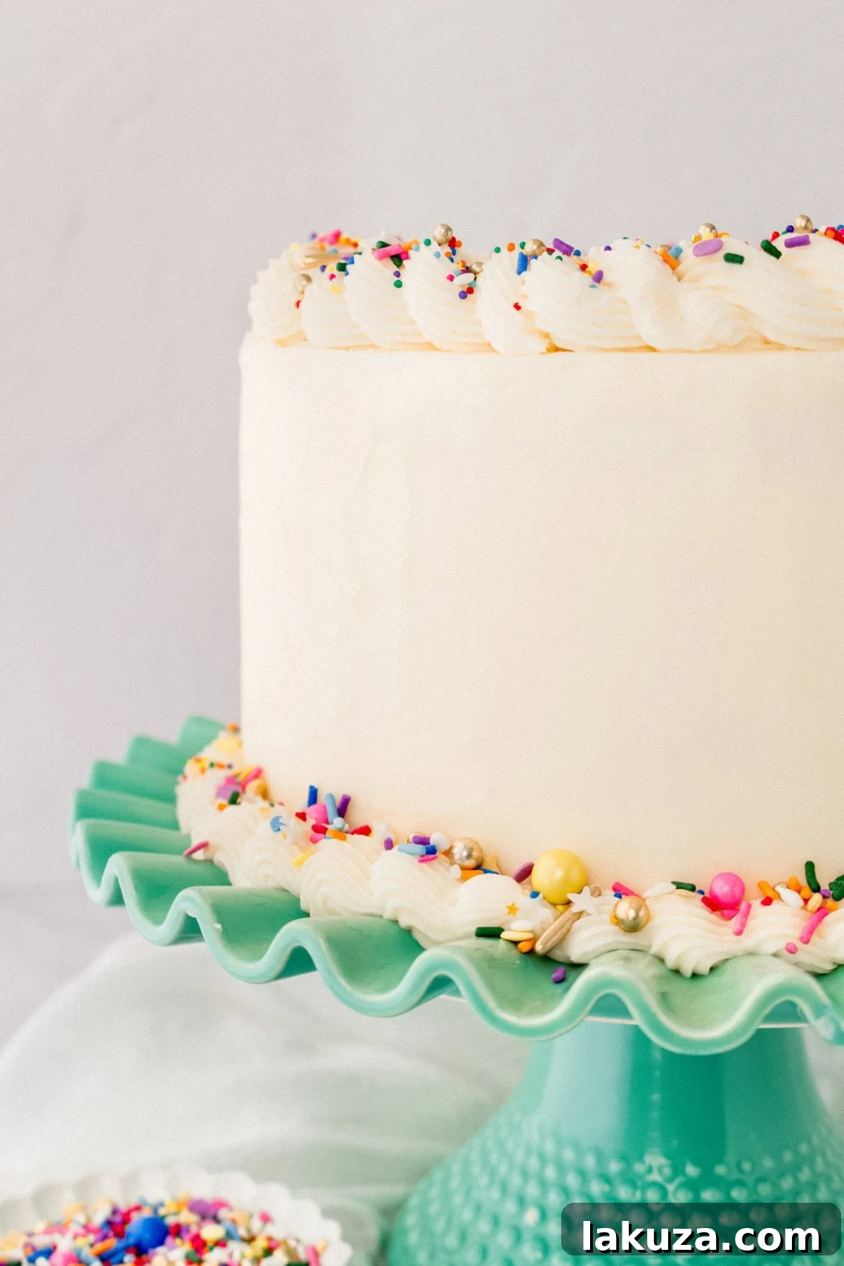 Joyful Sprinkle Celebration 3 A stunning multi-layered Funfetti or confetti cake adorned with abundant rainbow sprinkles, a perfect visual for homemade birthday celebrations.