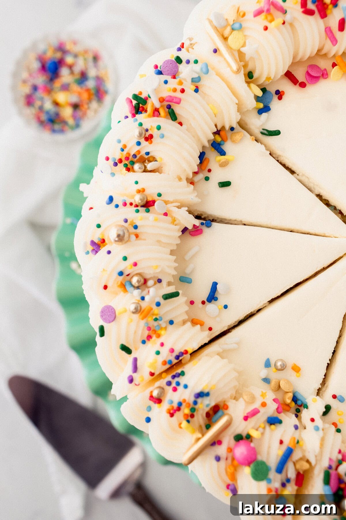 Joyful Sprinkle Celebration 4 A close-up shot of a lavishly frosted Funfetti cake with vibrant sprinkles, showcasing its fluffy layers and the smooth texture of the cream cheese buttercream.