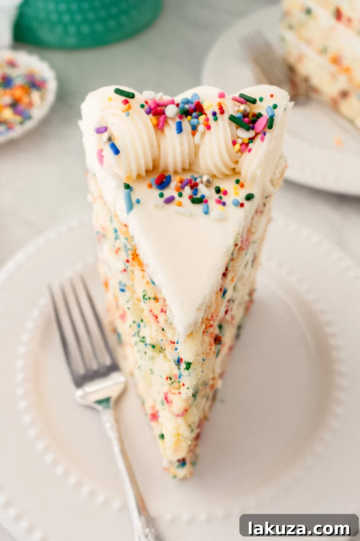 Joyful Sprinkle Celebration 8 An elegantly frosted Funfetti birthday cake, generously covered in cream cheese buttercream and topped with an array of rainbow sprinkles, presented as a celebratory dessert.