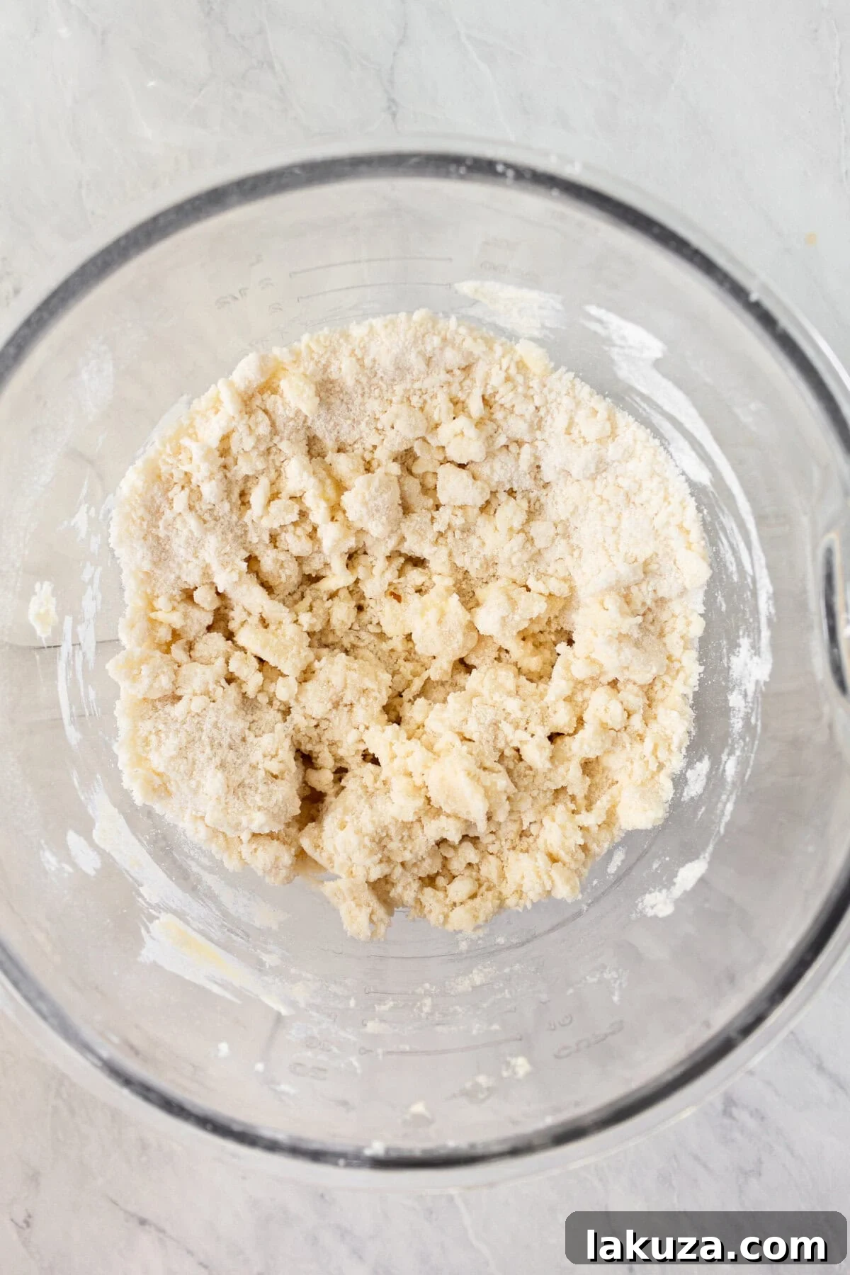 Joyful Sprinkle Celebration 9 Coarse, sandy Funfetti cake batter in a stand mixer bowl after butter has been incorporated into the dry ingredients, showing the initial mixing stage.