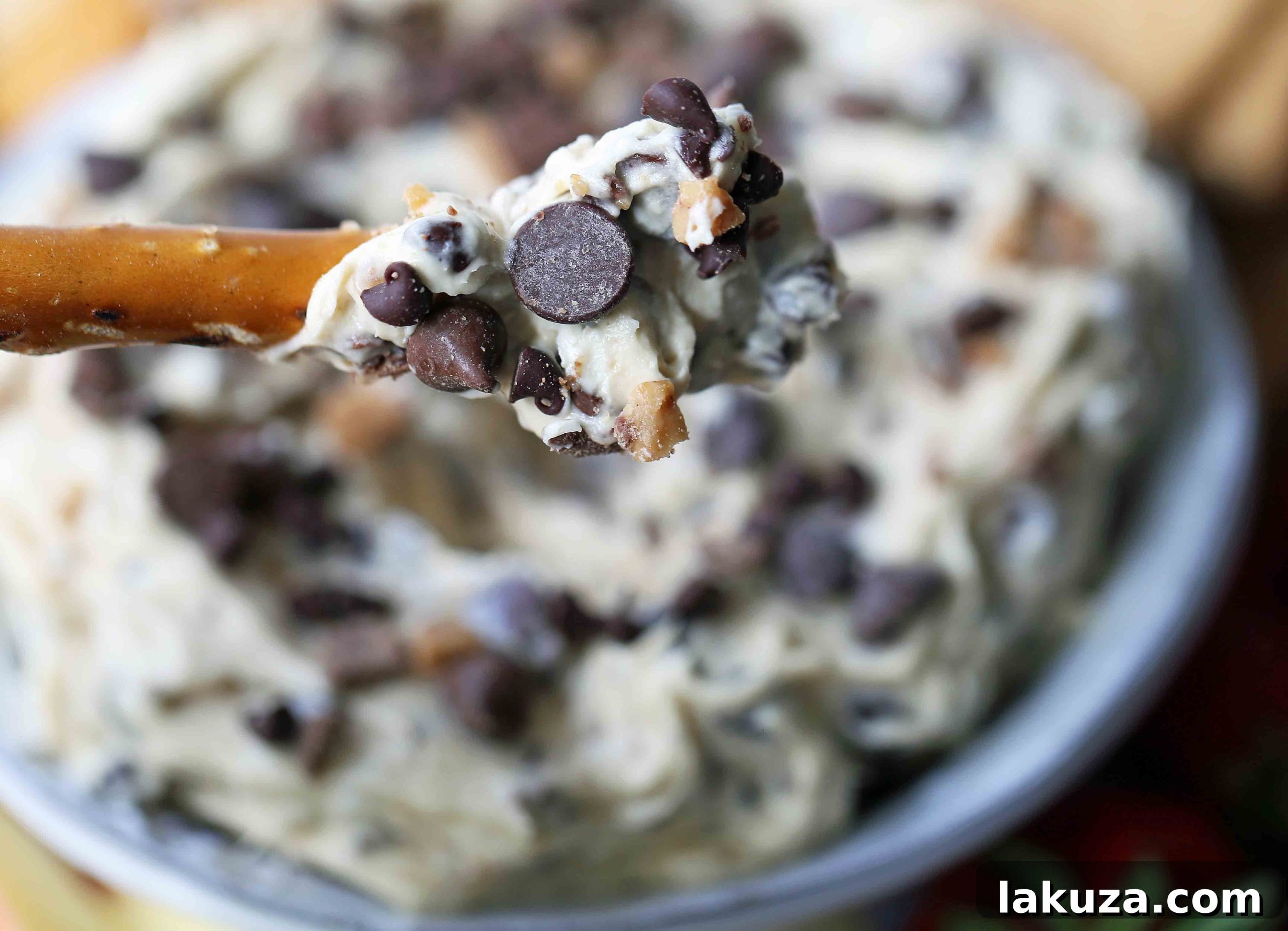 A large bowl of Chocolate Chip Cookie Dough Dip, garnished with extra chocolate chips and toffee, presented beautifully for a gathering.