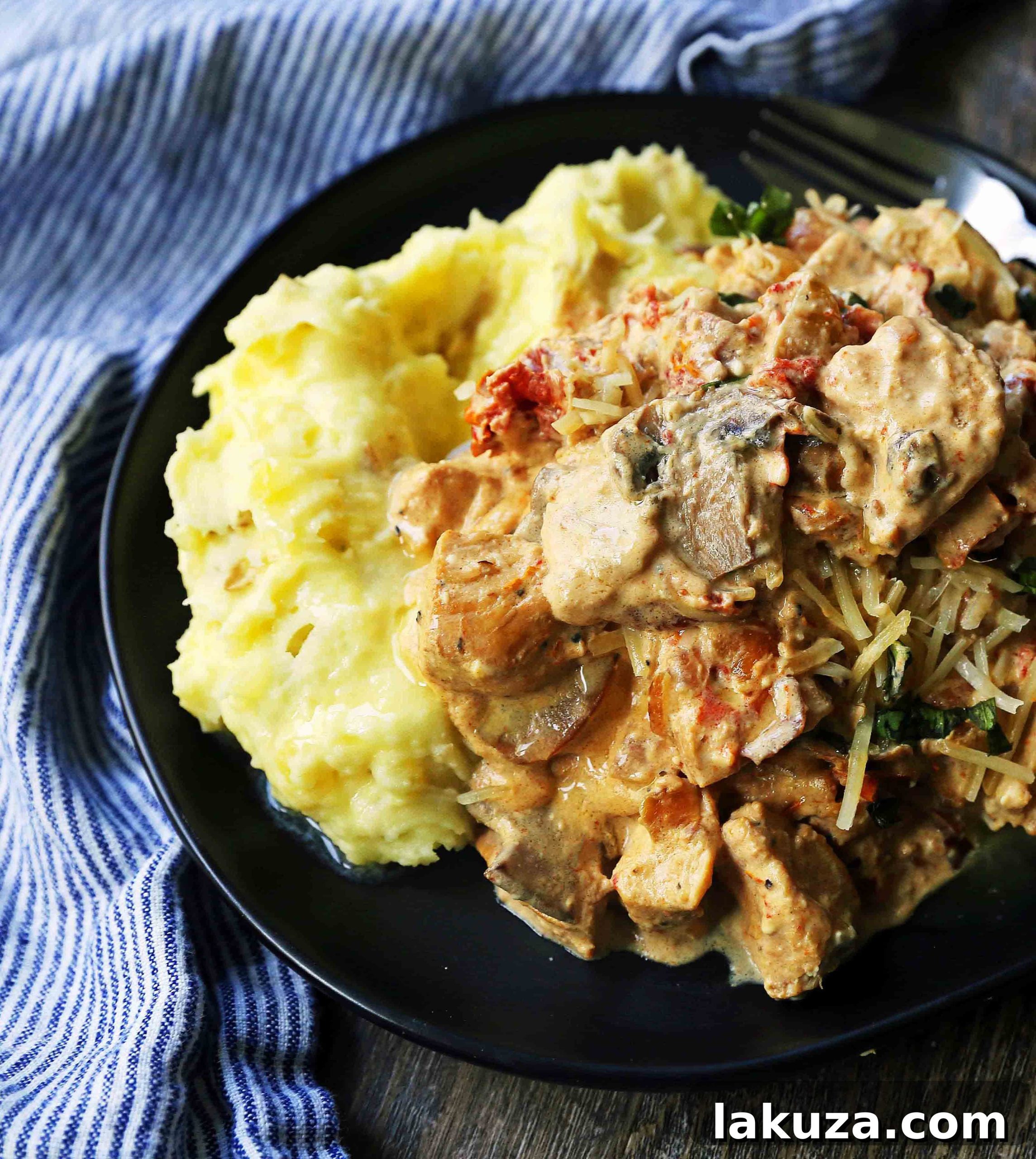 A serving of Slow Cooker Creamy Tuscan Chicken, garnished with fresh basil.