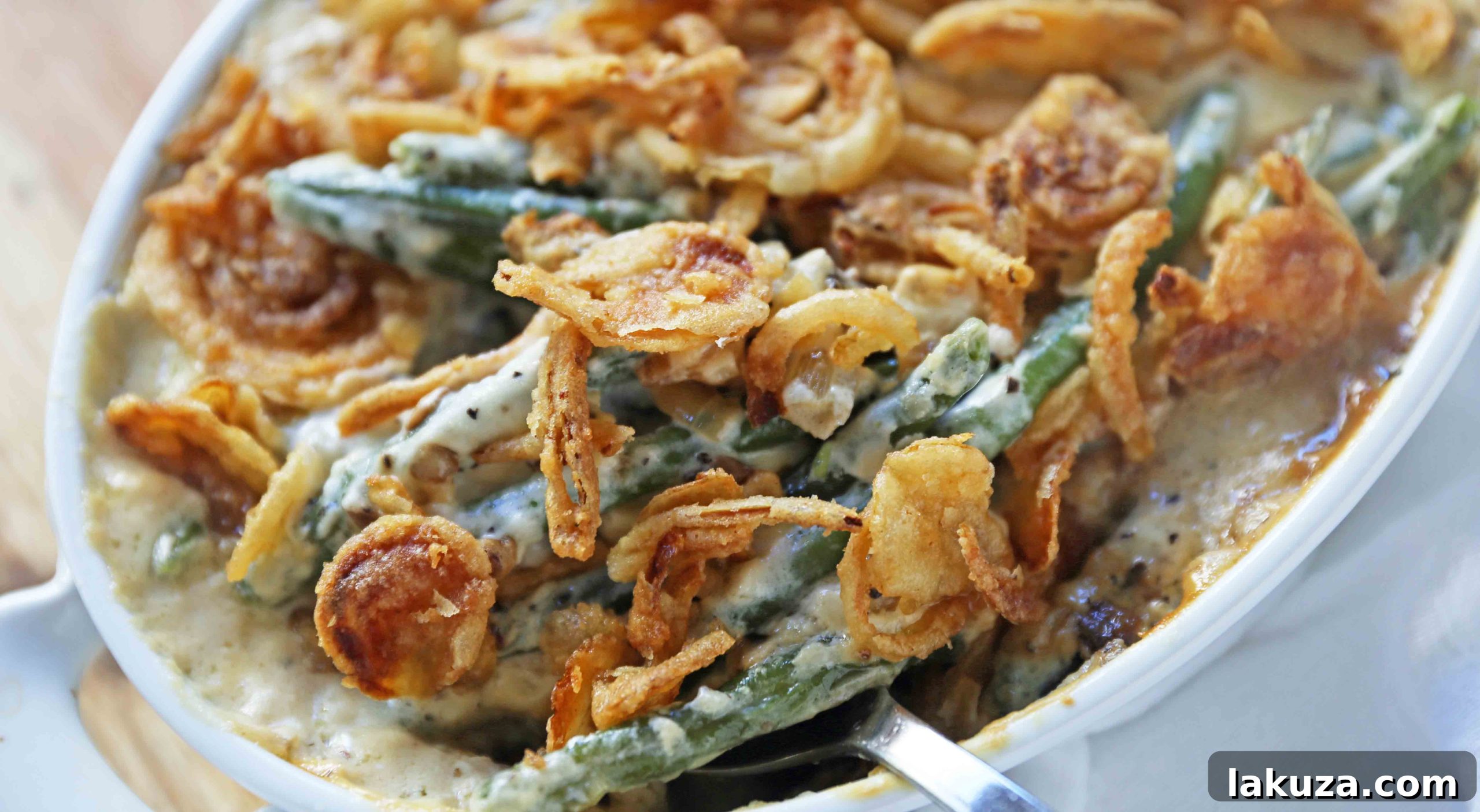 A generously topped Green Bean Casserole with golden-brown crispy fried onions, straight from the oven.