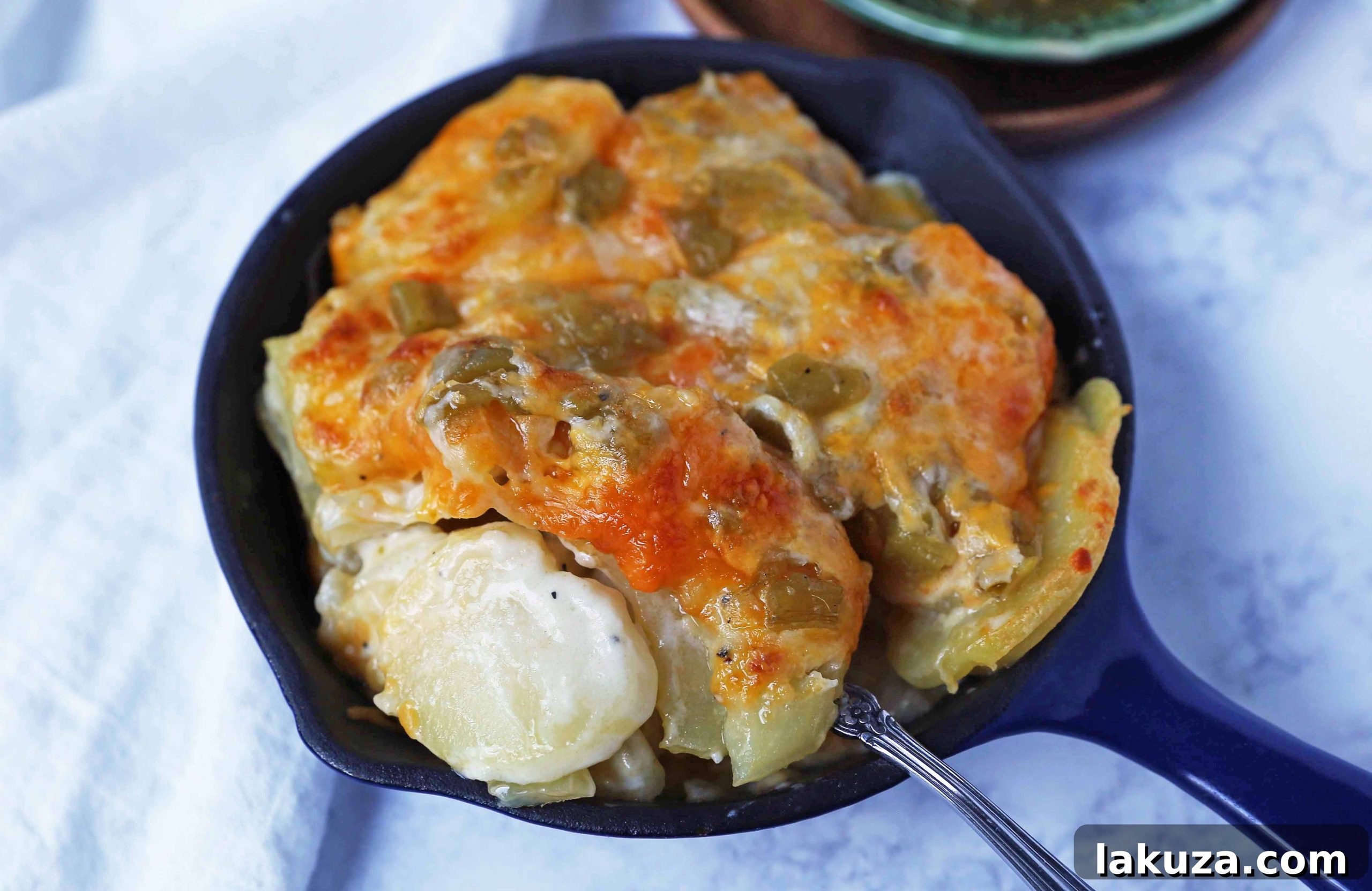Mouthwatering Cheesy Potato Gratin 9 A large pan of cheesy potatoes au gratin, garnished with fresh herbs, indicating a ready-to-serve dish for a crowd.