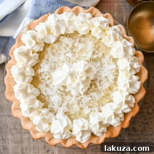 This Coconut Cream Pie is made with a homemade coconut custard filling in a buttery pie crust topped with fresh whipped cream and toasted coconut. This is the famous Dahlia Bakery's secret coconut cream pie recipe.