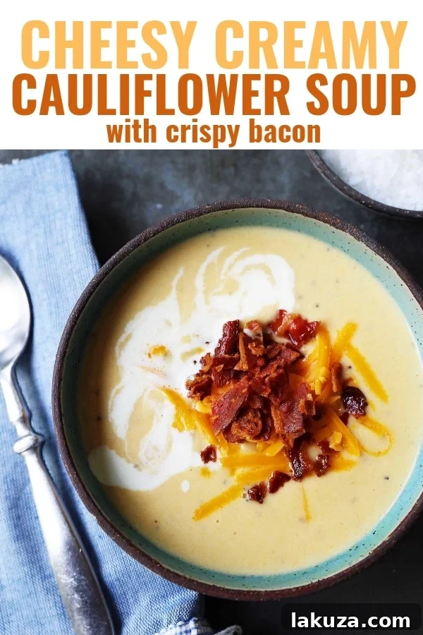 Rich and Creamy Cauliflower Cheese Soup 7 A cozy, inviting shot of a bowl of cheesy cauliflower soup with a spoon, ready to be enjoyed.