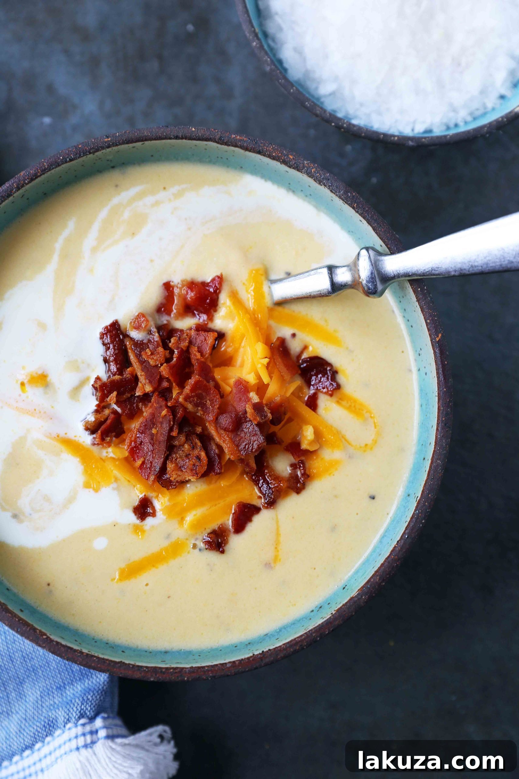 Rich and Creamy Cauliflower Cheese Soup 6 A large pot of creamy cheesy cauliflower soup simmering on the stovetop, showcasing its rich texture.
