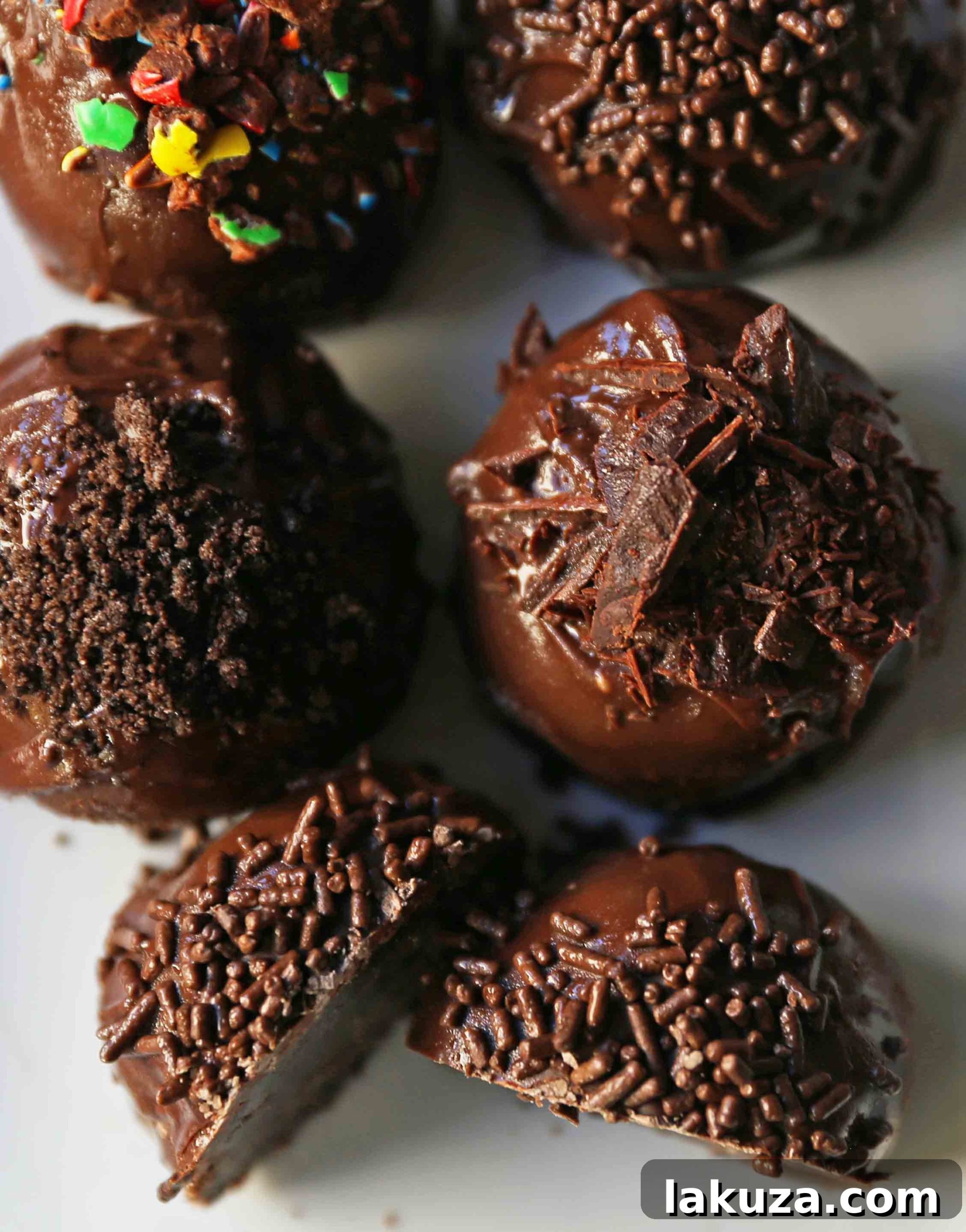 Creamy Oreo Bliss 9 Close-up of freshly made Oreo truffles, half-dipped in chocolate with various toppings.