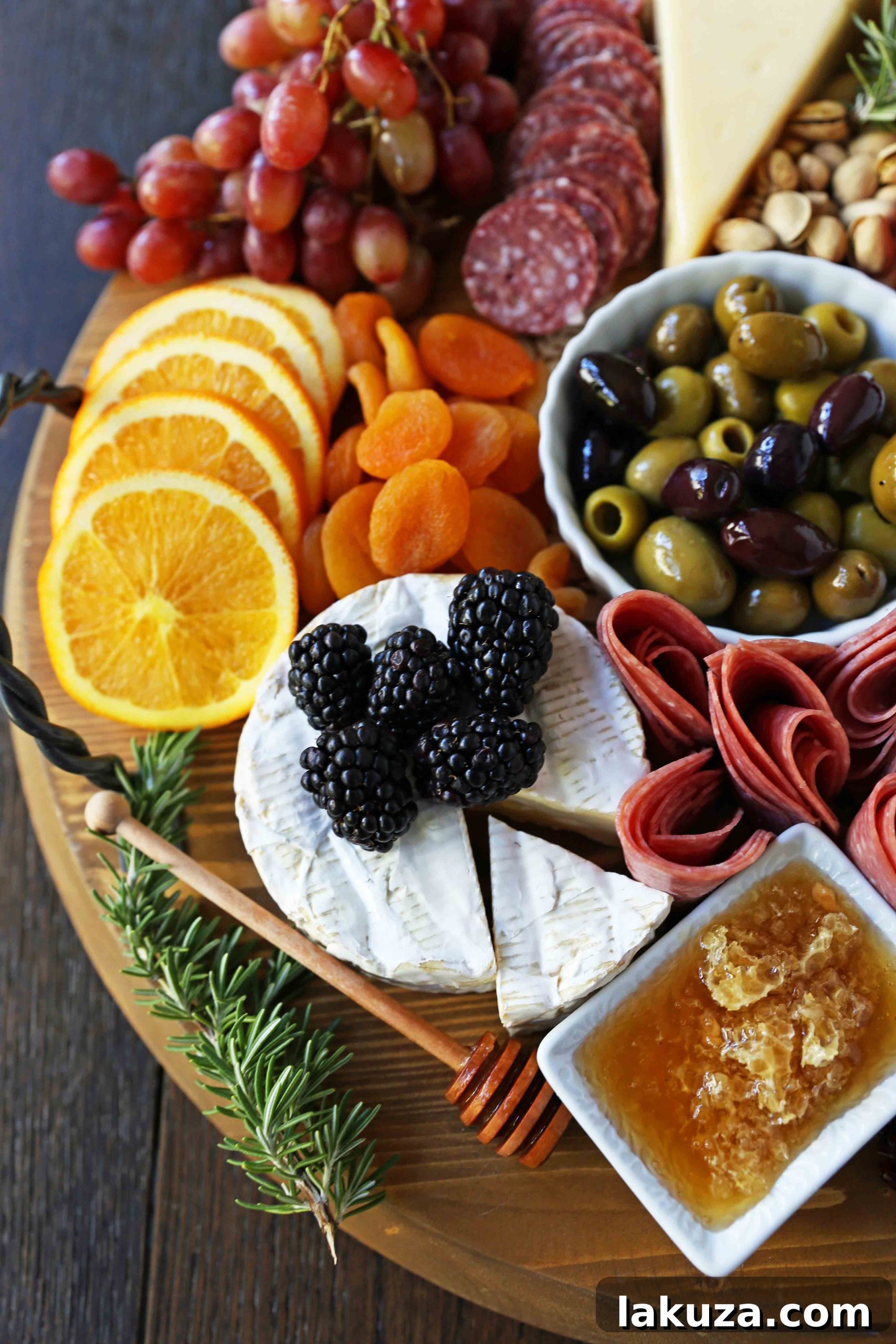 Step-by-step guide on how to build a charcuterie board with a variety of cheeses, cured meats, fresh fruits, nuts, and crackers for an elegant and easy appetizer.