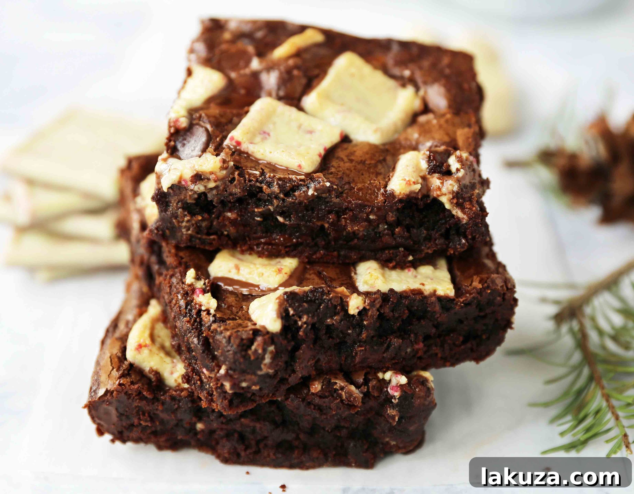 Close-up of a single square of Peppermint Bark Brownie, showcasing its fudgy texture and embedded peppermint pieces
