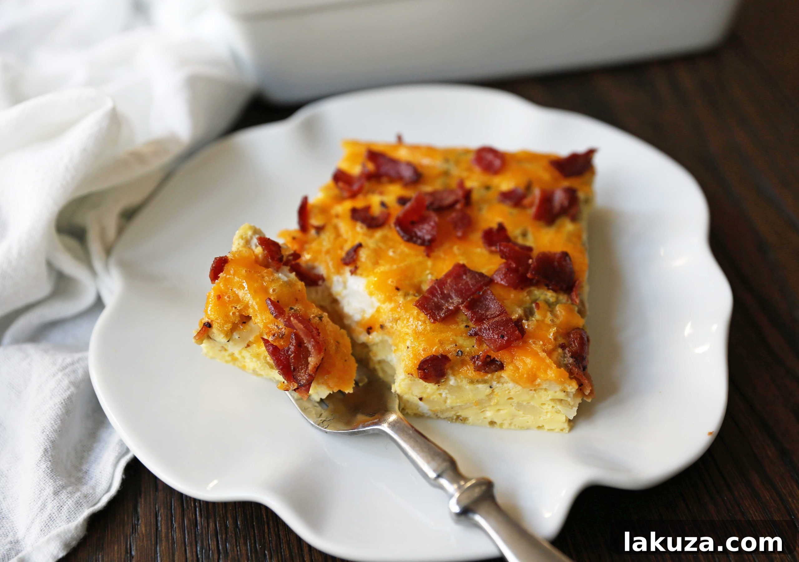 Savory Breakfast Bake 5 Bacon Egg and Cheese Casserole in a baking dish. Ready to serve, showcasing the golden-brown top and crispy bacon. Ideal for family breakfasts or holiday meals.