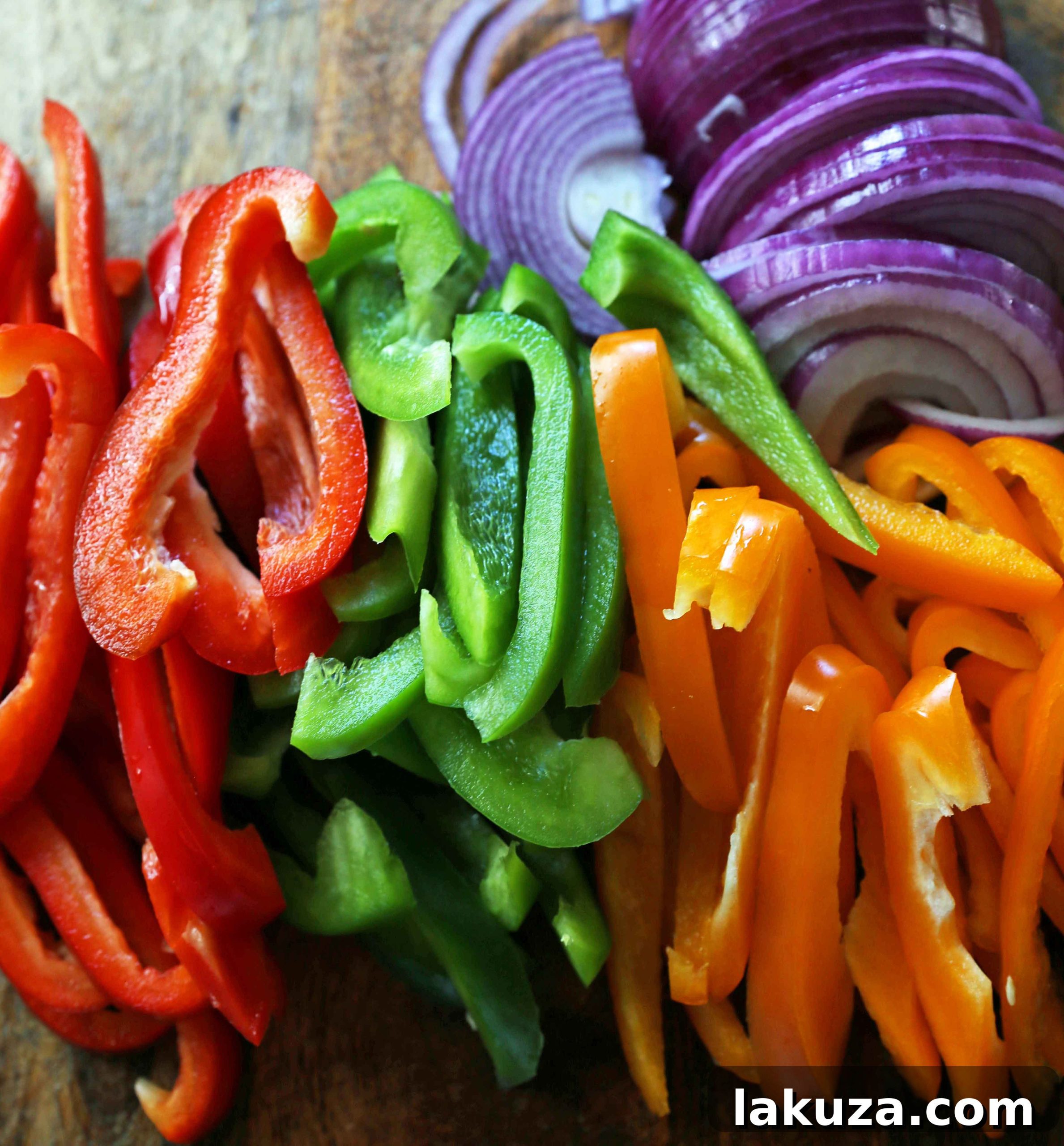 Fajita Ingredients Prepped: Sliced chicken, vibrant peppers, and onions in a mixing bowl, showcasing the readiness for the best chicken fajitas recipe.