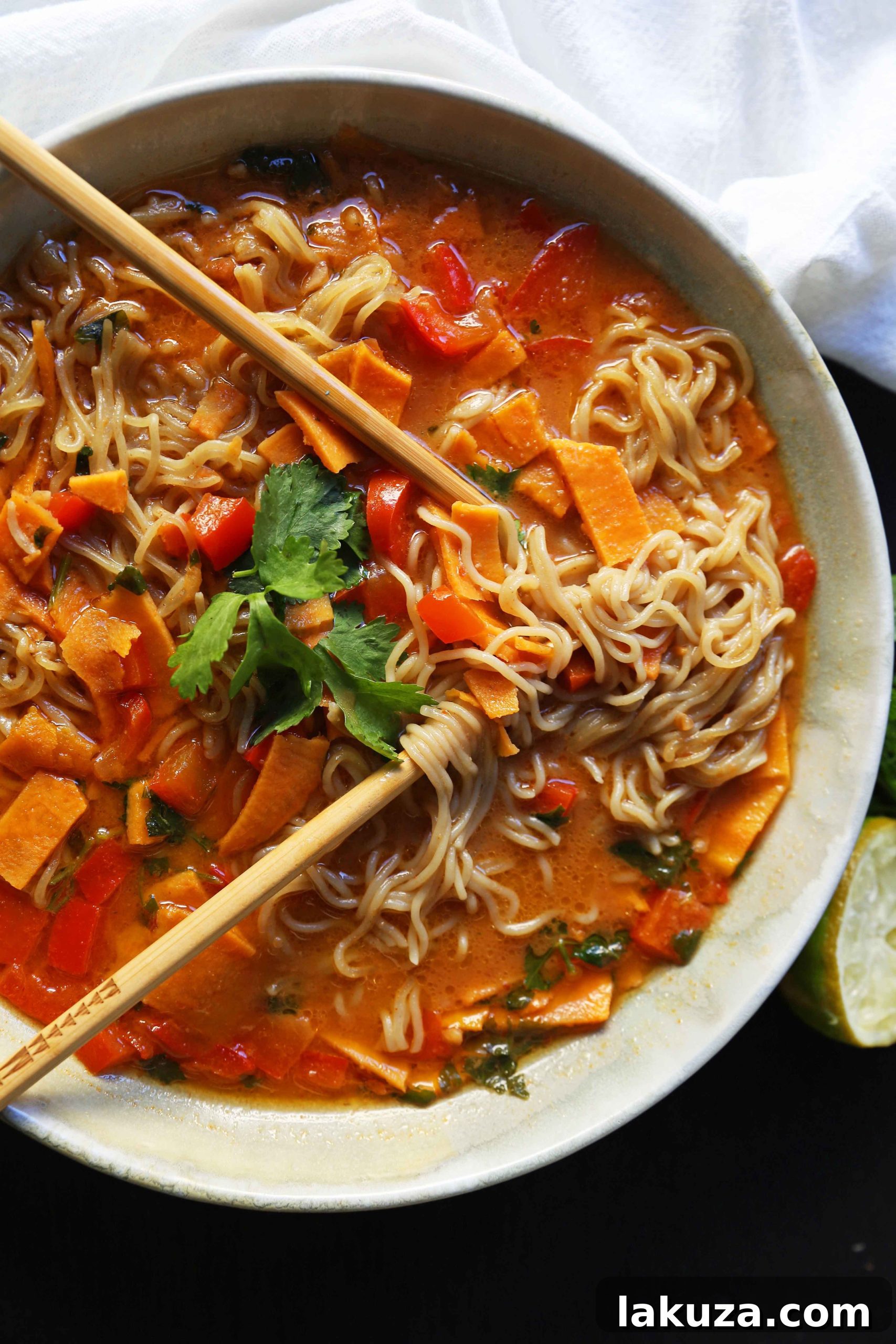 A vibrant bowl of Thai Coconut Curry Vegetable Soup, featuring rich coconut milk, aromatic spices, and a medley of fresh, colorful vegetables like red peppers and sweet potatoes, perfect for a healthy and satisfying meal.