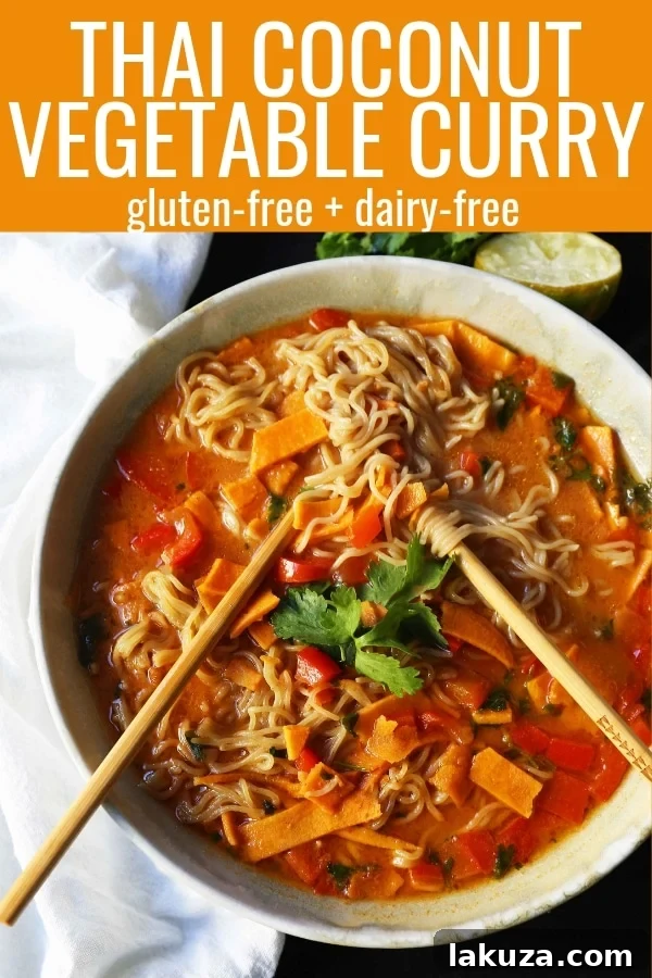 Artistically plated bowl of Thai Coconut Curry Vegetable Soup with ramen noodles, topped with cilantro, crushed peanuts, and fresh lime, ready for a satisfying, nutrient-rich dinner.