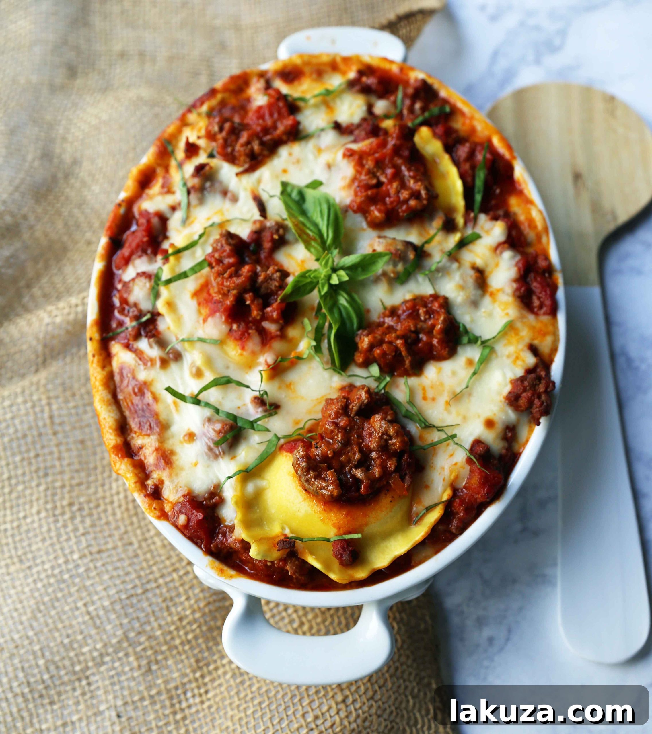 Ravioli Lasagna is a quick and easy lasagna recipe made with cheese ravioli, meat sauce, and melted mozzarella cheese. How to make the best ravioli lasagna for a family dinner. Modern Honey recipe.