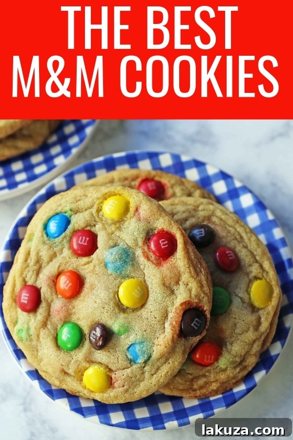 Soft and Chewy M&M Cookies: A close-up of a single M&M cookie, showing its texture and colorful candy pieces.