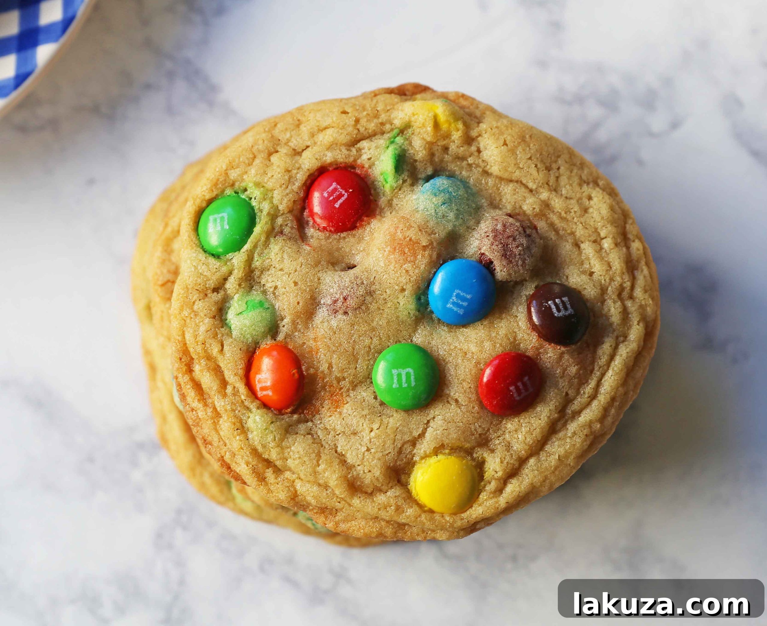 Soft and Chewy M&M Cookies: A stack of freshly baked M&M cookies on a wooden board, ready to be served.