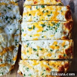 Quick and Easy Garlic Cheese Bread. Warm bread toasted and slathered with garlic butter and melted ooey gooey cheese. Garlic Cheese Bread is the perfect side dish or appetizer.