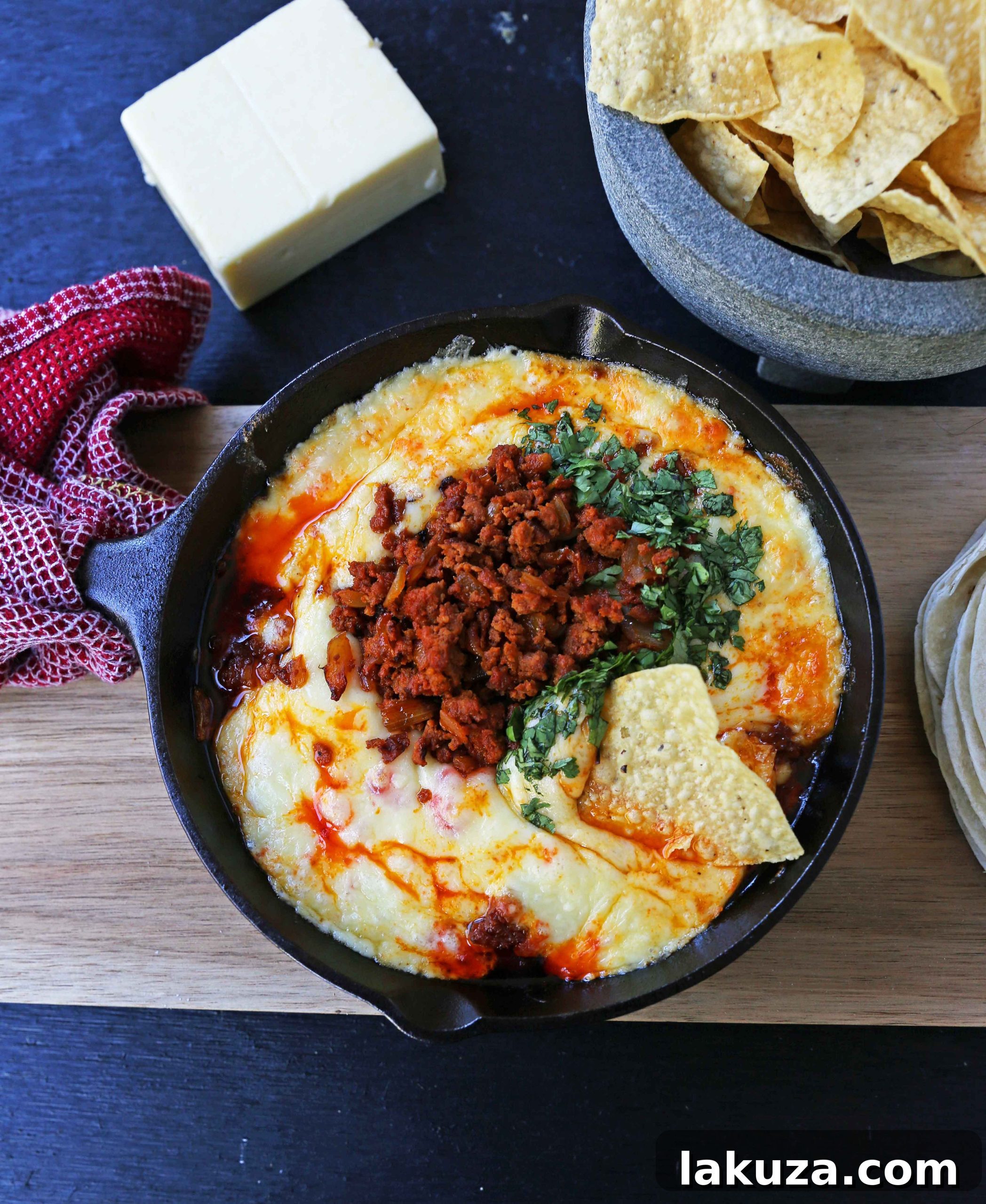 Queso Fundido with Chorizo. A skillet of melted Mexican cheeses seasoned with peppers, onions, and spicy Mexican chorizo sausage and served with hot tortillas or chips. The perfect Mexican appetizer!
