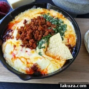 Queso Fundido with Chorizo. A skillet of melted Mexican cheeses seasoned with peppers, onions, and spicy Mexican chorizo sausage and served with hot tortillas or chips. The perfect Mexican appetizer!