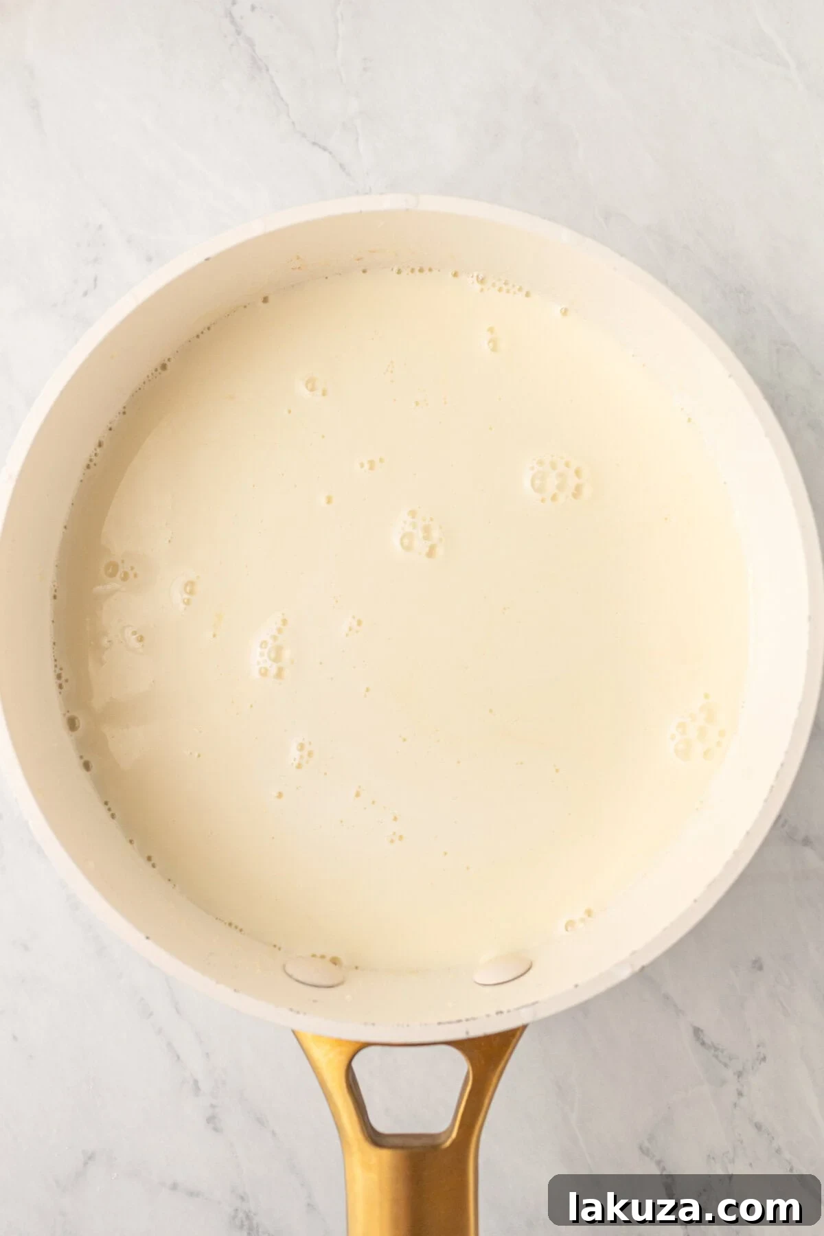 Cooking and heating the cream and sugar to make homemade creme brulee