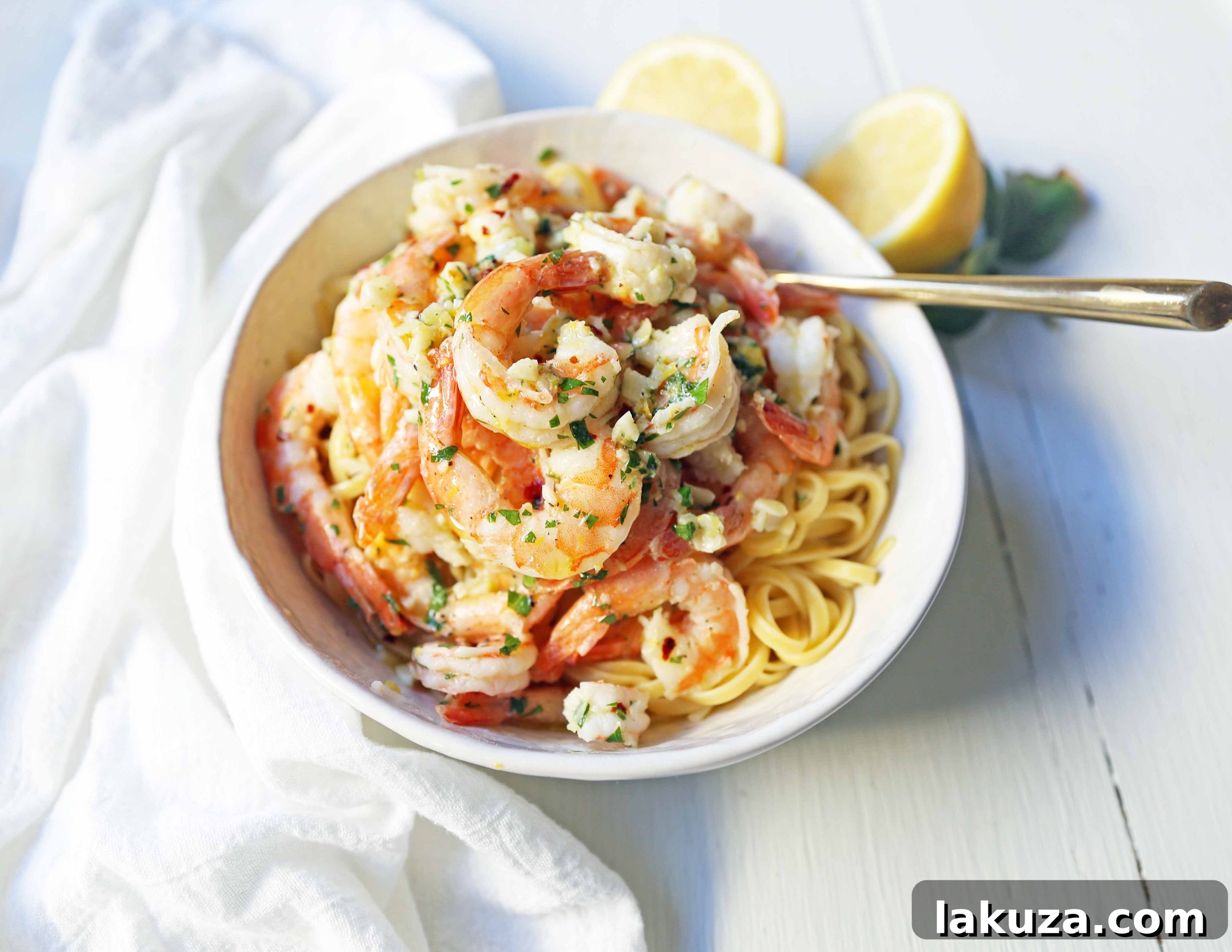 Zesty Lemon Garlic Shrimp Linguine 3 Close-up of perfectly cooked shrimp in a vibrant lemon-garlic butter sauce with fresh parsley, ready to be tossed with linguine.