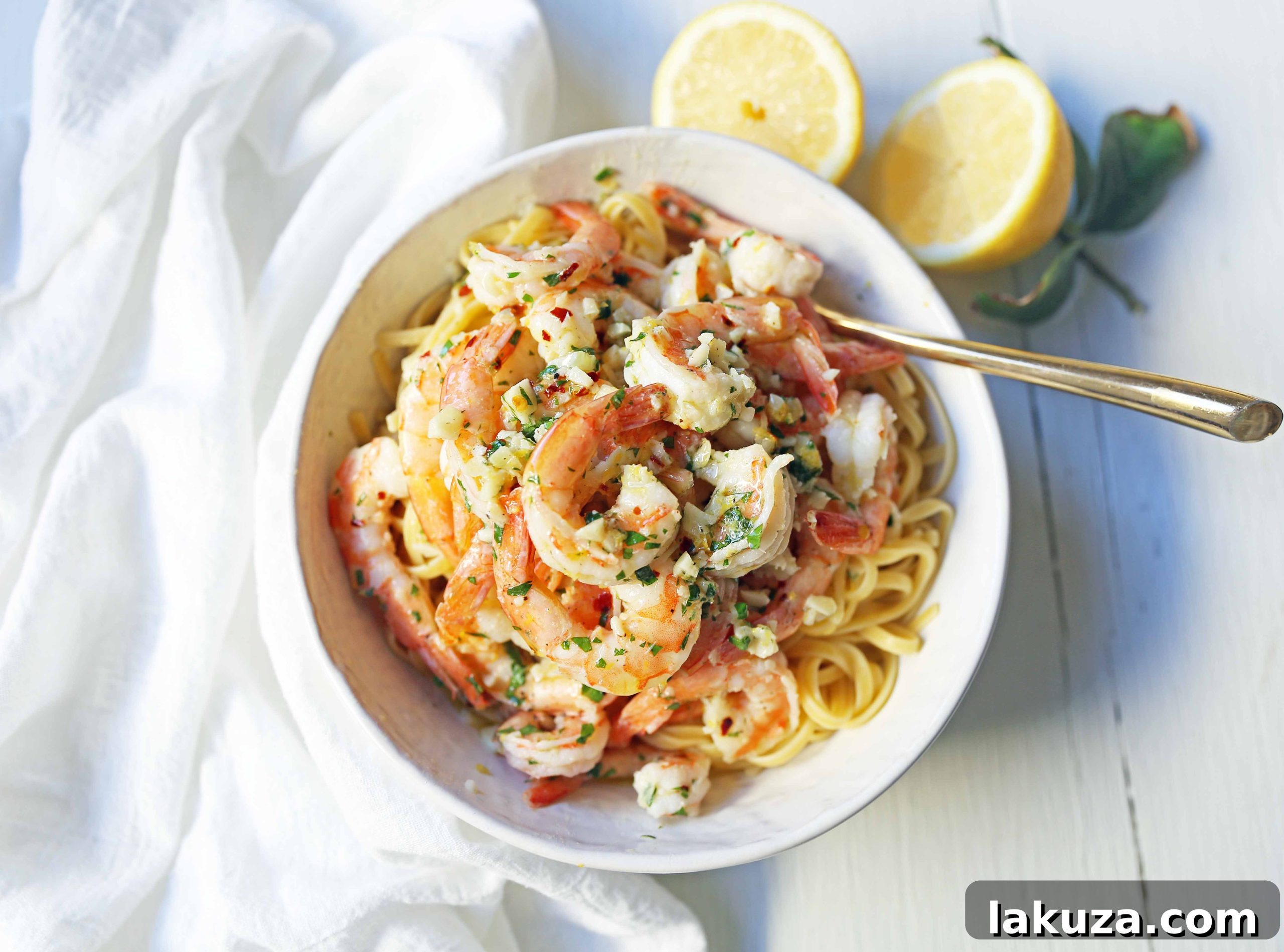 Zesty Lemon Garlic Shrimp Linguine 4 A serving of Shrimp Scampi Linguine garnished with fresh parsley and a lemon wedge, showcasing its appealing presentation.