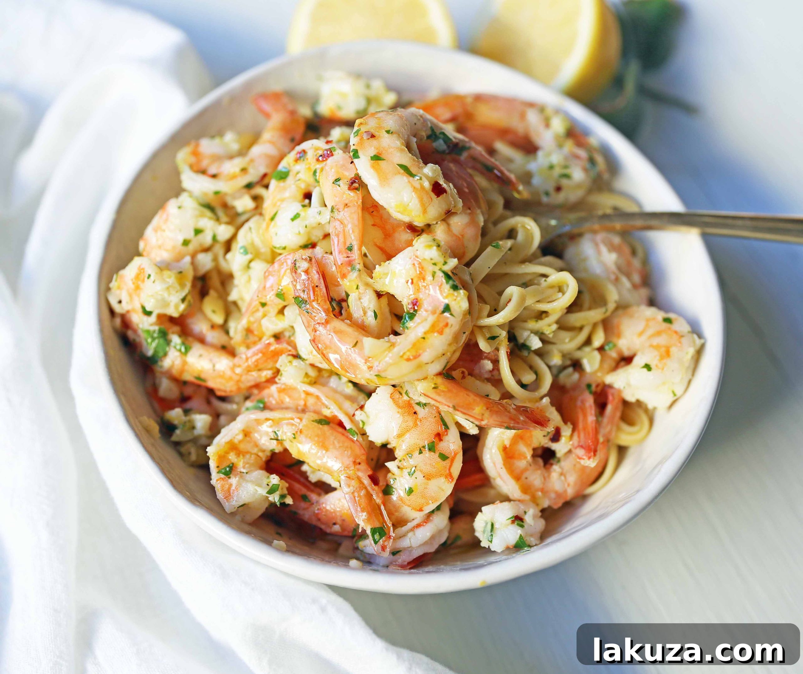 Zesty Lemon Garlic Shrimp Linguine 5 A generous serving of Shrimp Scampi Linguine, ready to be enjoyed, with a focus on its rich, buttery sauce and plump shrimp.