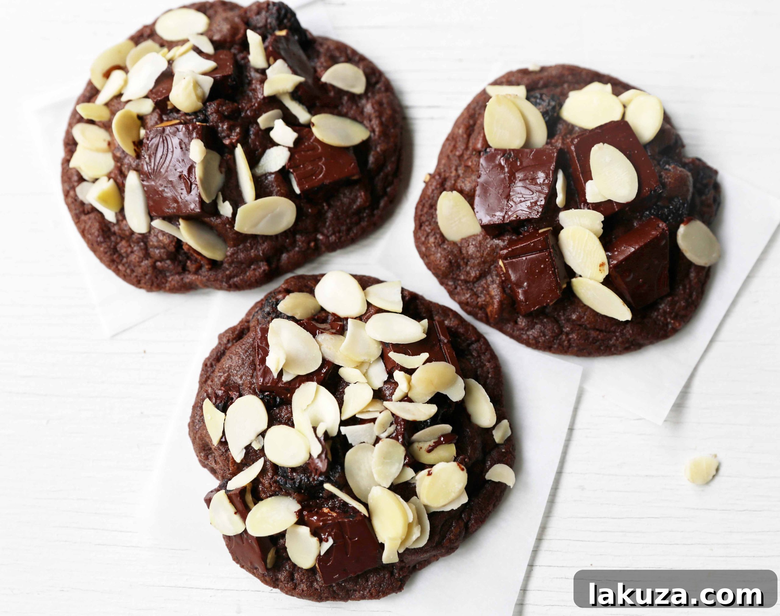 Rich Chocolate Cherry Bliss 4 Three decadent Chocolate Cherry Almond Cookies on a rustic wooden board