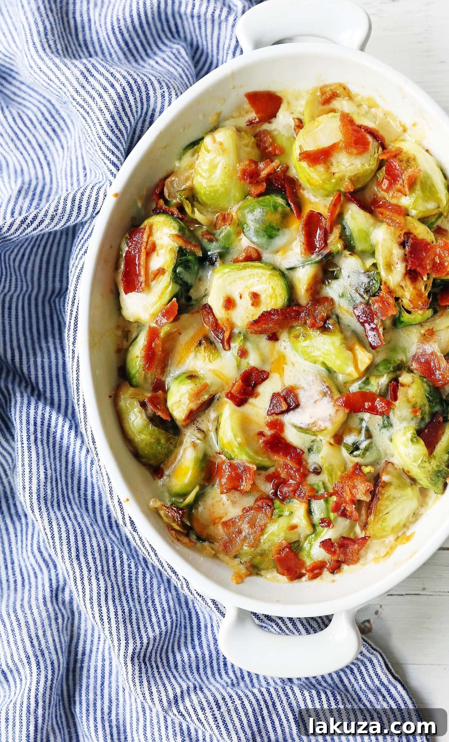Rich and creamy cheesy brussels sprouts baked to perfection with crispy bacon. An irresistible side dish.