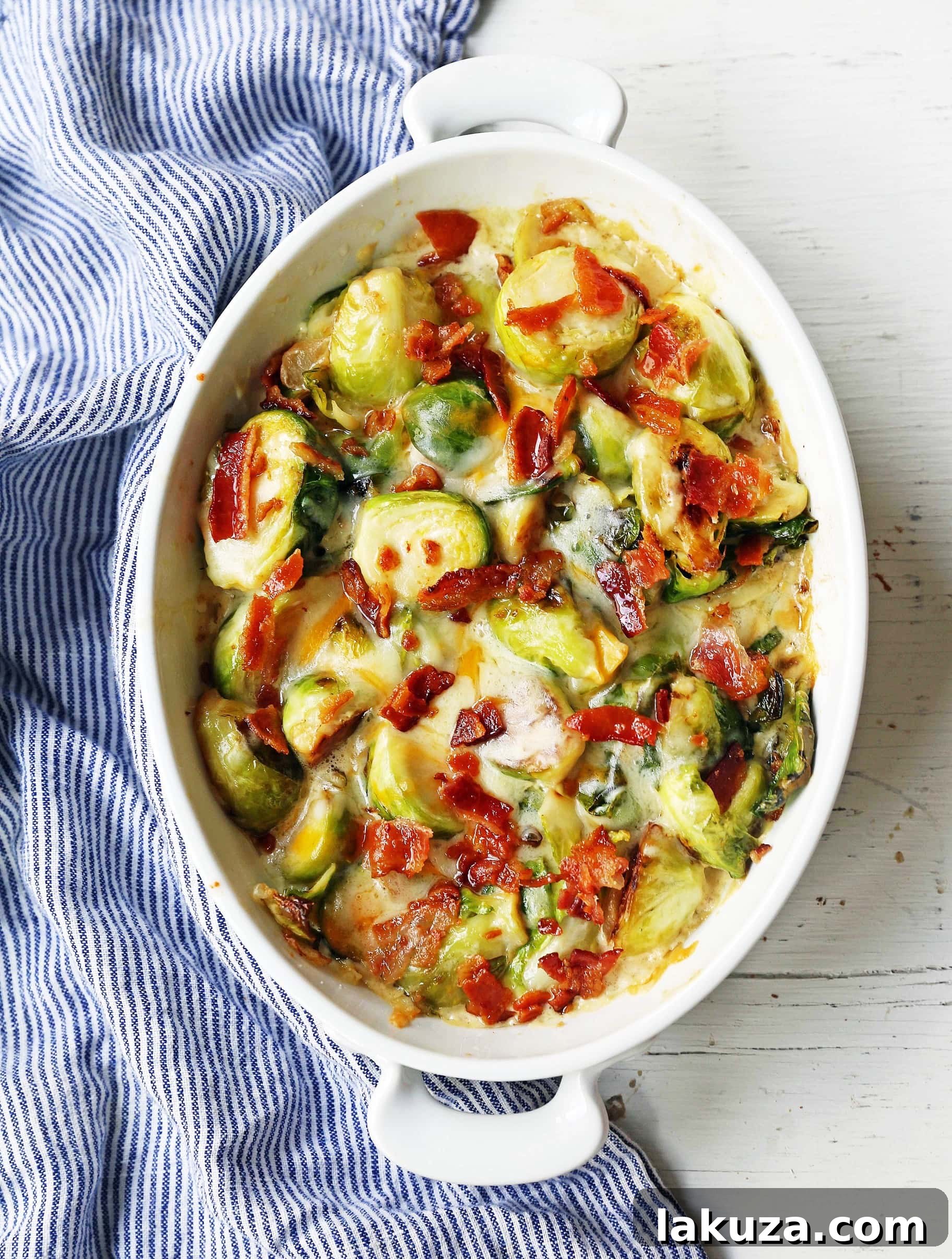 Delicious creamy cheesy brussels sprouts with bacon, cooked in a skillet.