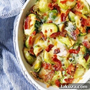 Creamy Cheesy Brussels Sprouts with Bacon. Roasted brussels sprouts with crispy bacon, a creamy sauce, and melted cheese.
