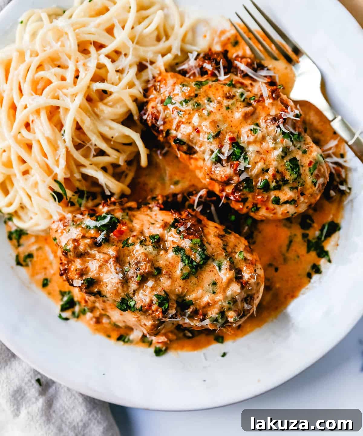 Close-up of Marry Me Chicken with creamy sauce, basil, and parmesan. A delicious and famous skillet chicken recipe.