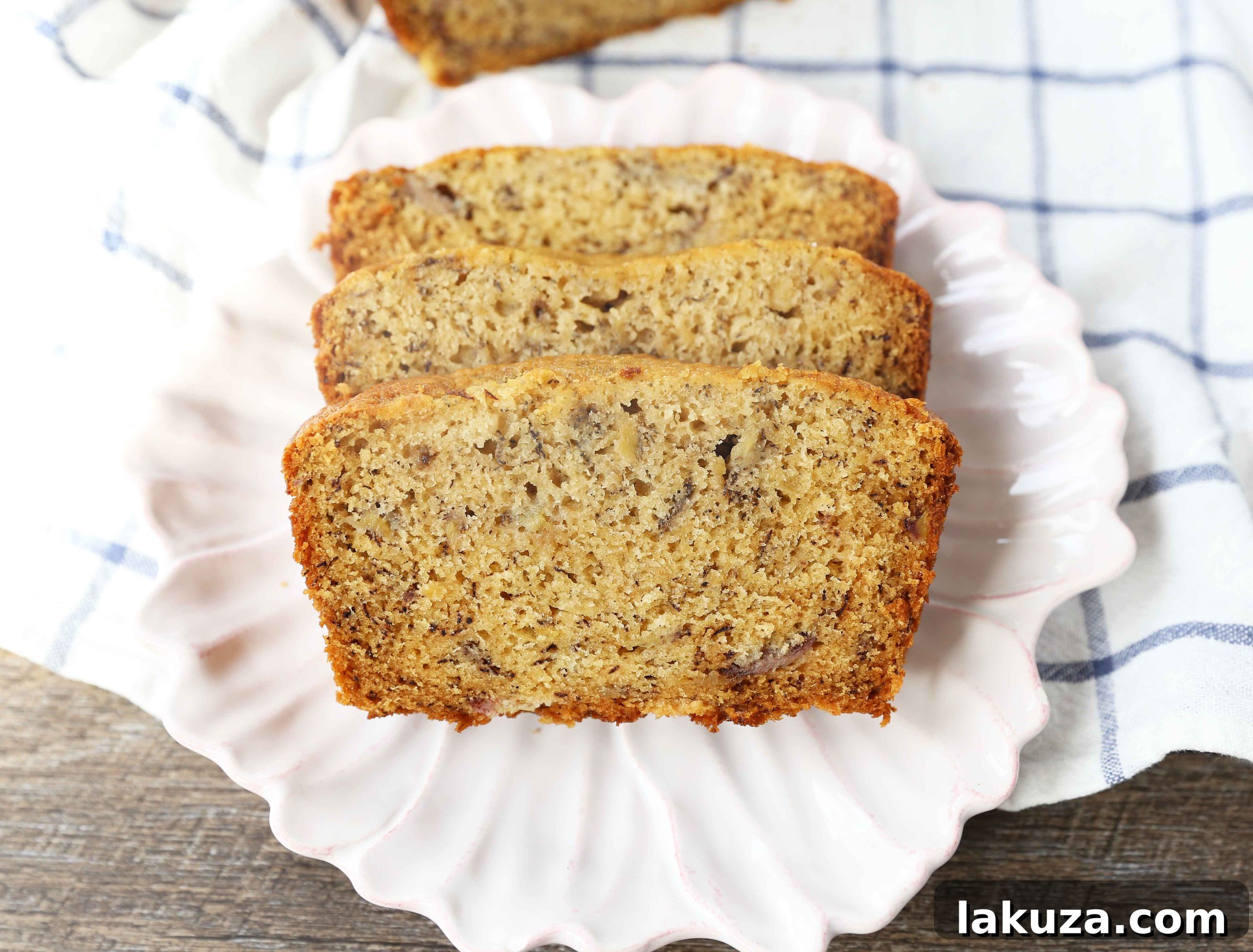 Two loaves of golden brown, moist banana bread cooling on a rack