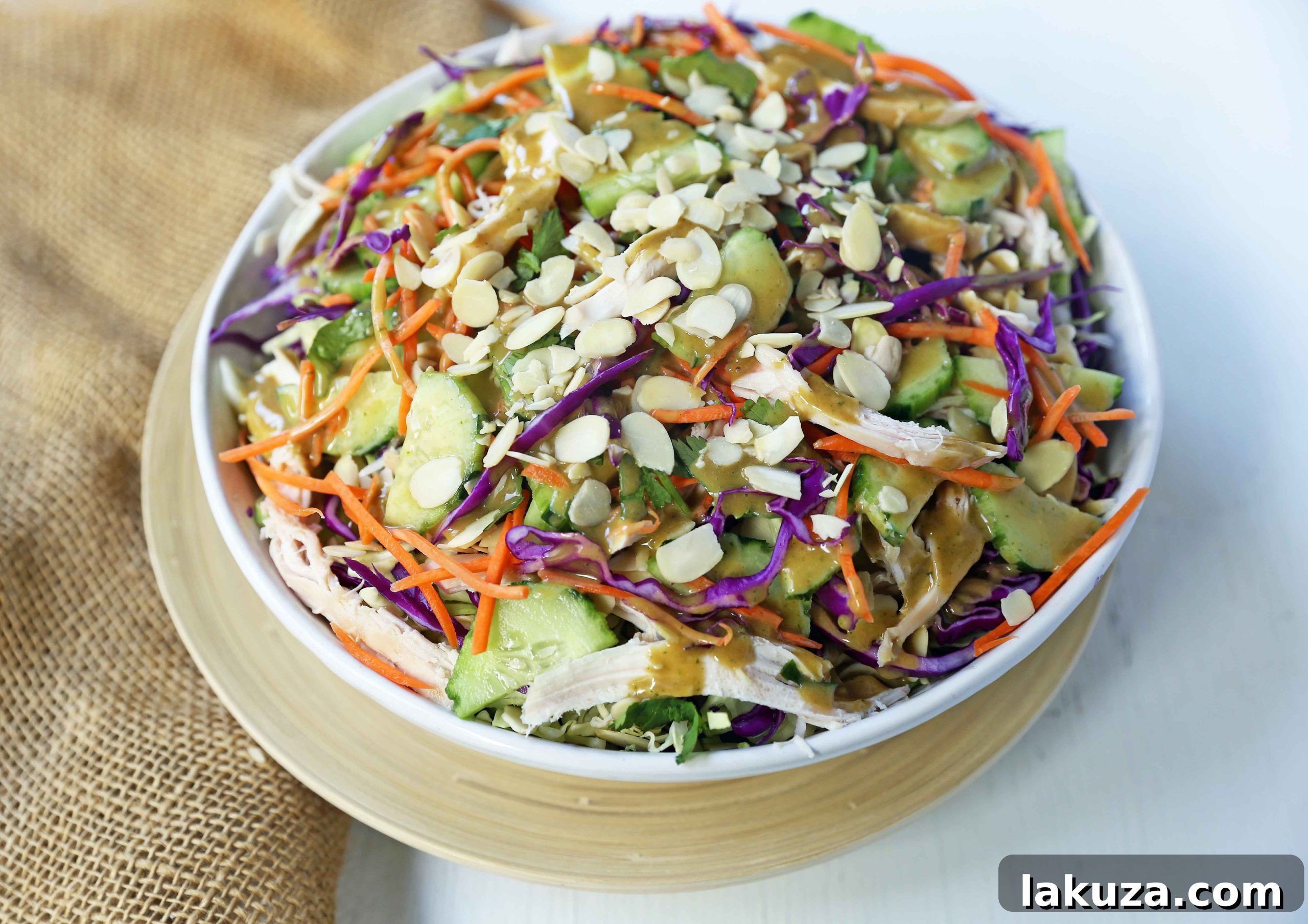 Thai Chicken Salad in a bowl, showcasing fresh ingredients before dressing.