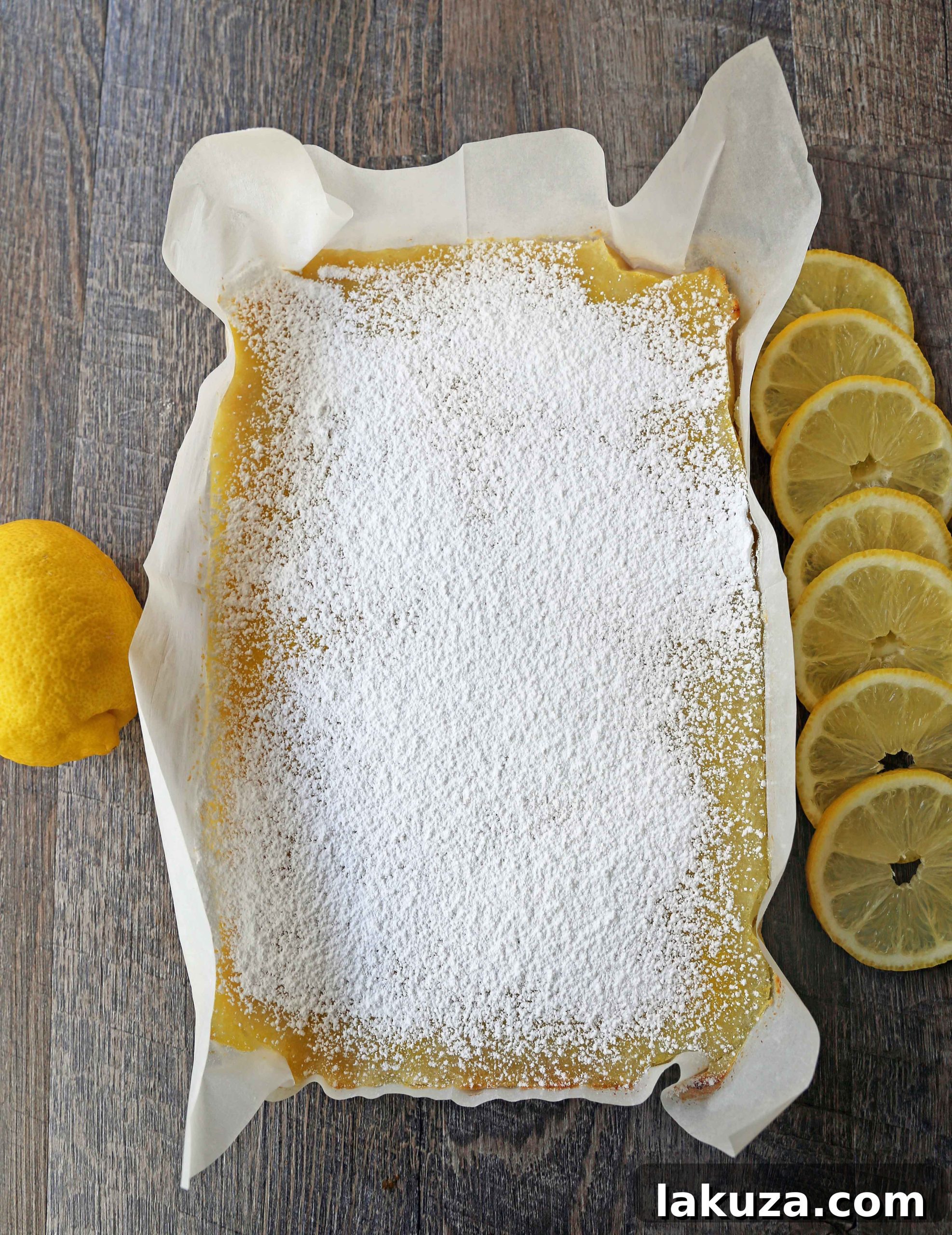 Sunshine Lemon Squares 8 A stack of perfectly cut, golden lemon bars on a serving plate, dusted with powdered sugar. Ready to be enjoyed.