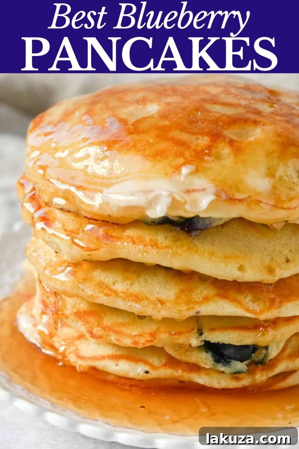 Bursting Blueberry Pancakes 11 A mouth-watering close-up of a stack of fluffy buttermilk blueberry pancakes with syrup, showcasing their perfect texture.