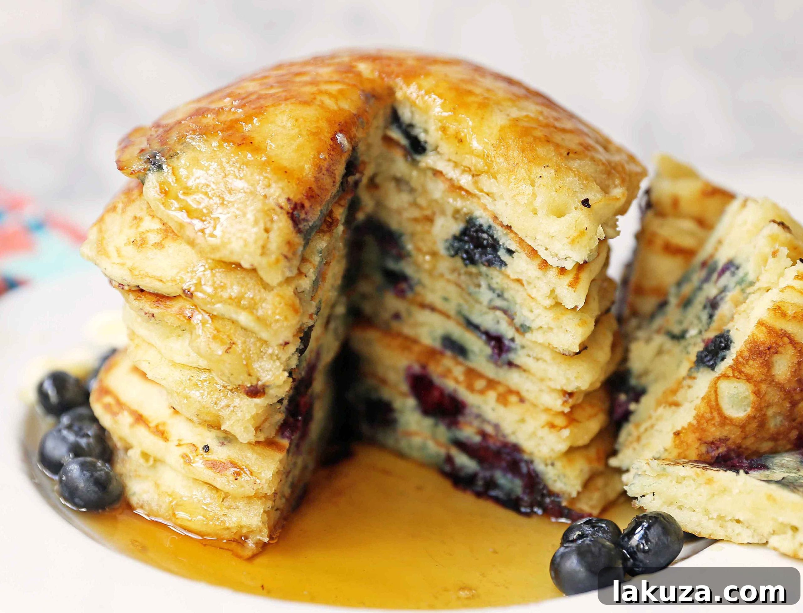 Bursting Blueberry Pancakes 5 Dry ingredients for blueberry pancakes, including flour, sugar, baking soda, and baking powder, measured in bowls.