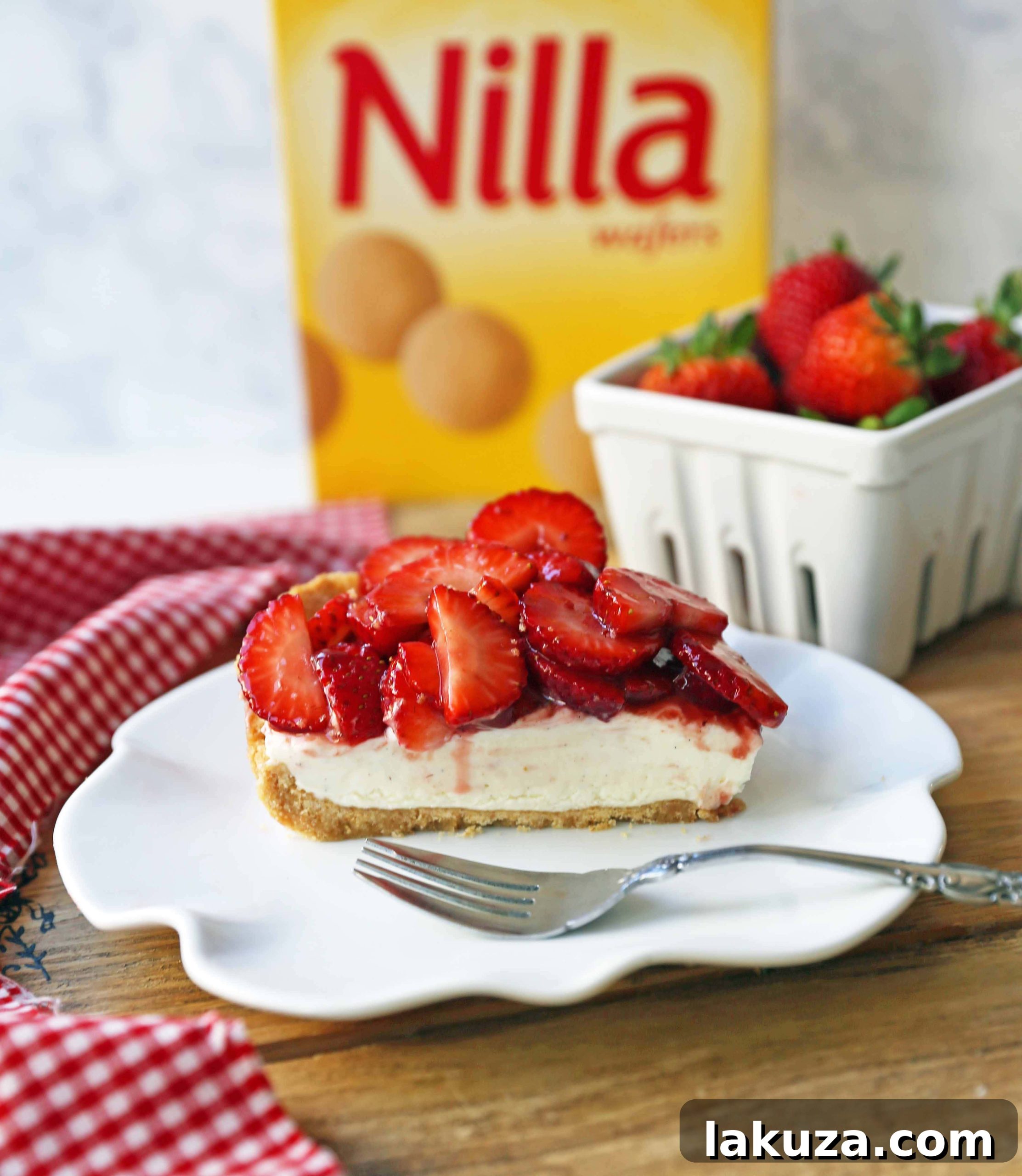 A large, perfectly sliced Strawberry Cream Cheese Pie with several slices removed, showing the layers of crust, filling, and strawberries.