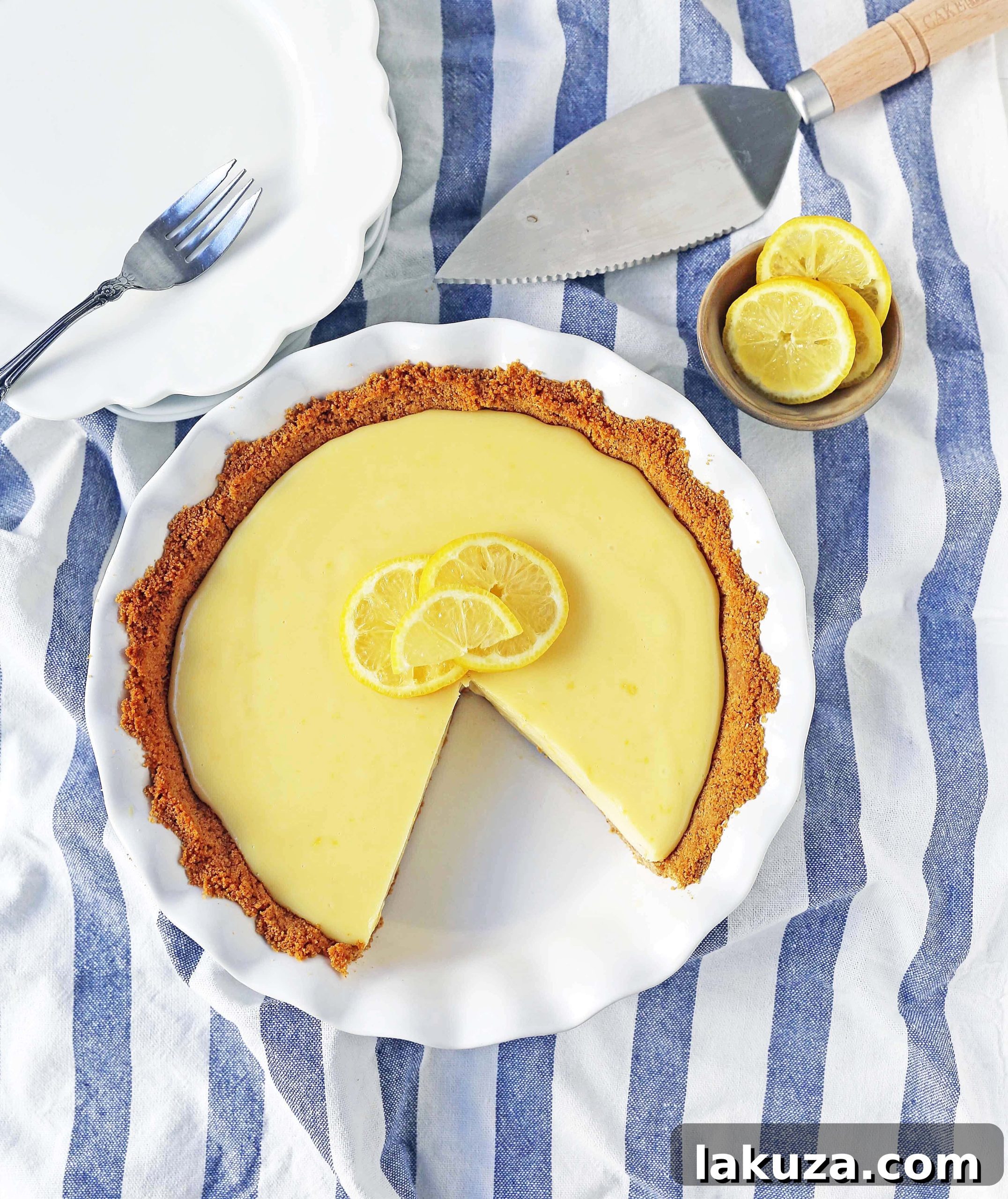 A side view of the Lemon Cream Pie, showing the distinct layers of crust, filling, and whipped cream, highlighting its inviting and decadent texture.
