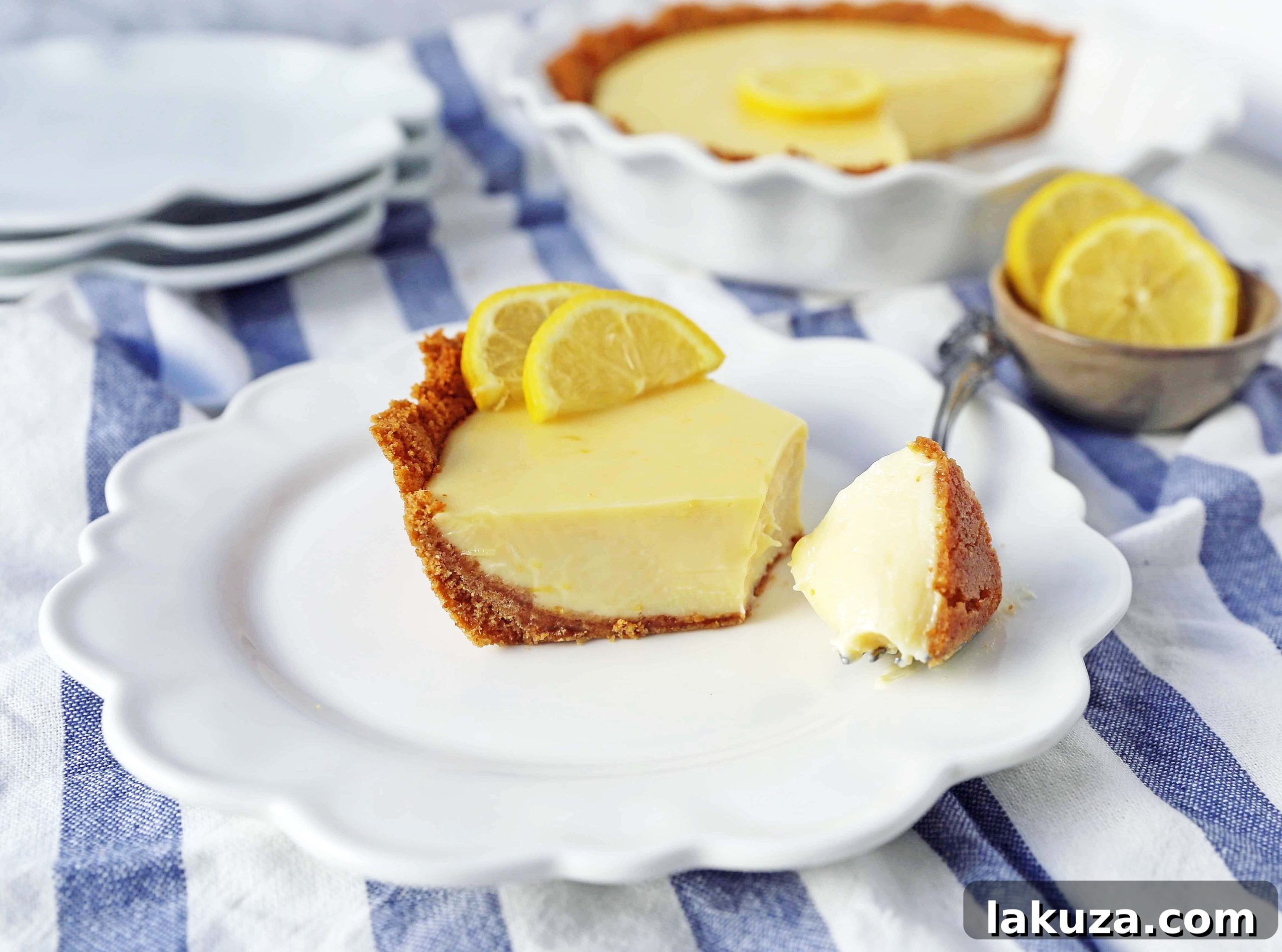 Another beautiful angle of the Lemon Cream Pie, emphasizing its creamy texture and the vibrant yellow of the lemon filling, topped with a generous swirl of whipped cream.