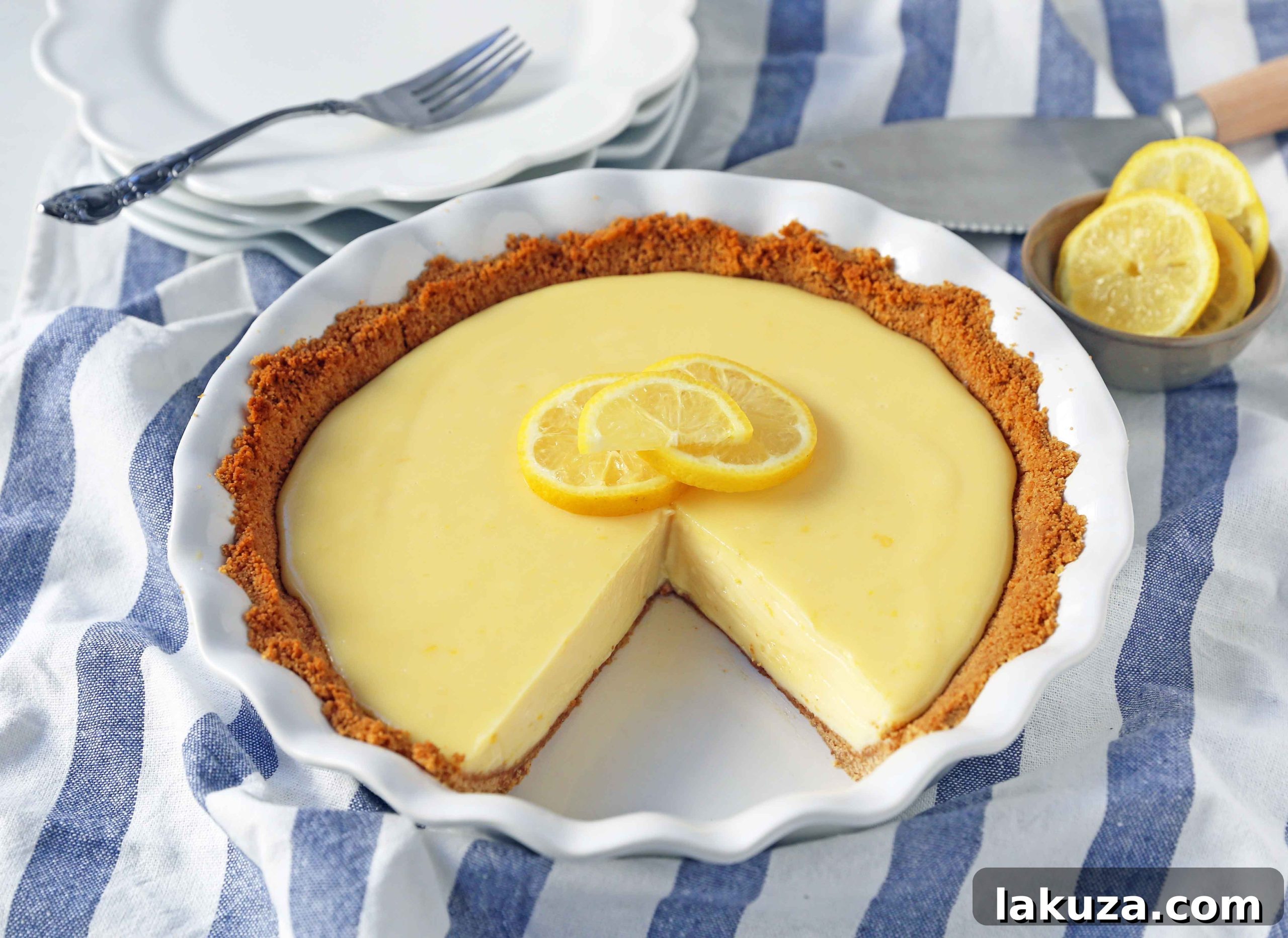 A close-up shot of the Lemon Cream Pie, showing a clean slice with a perfect filling-to-crust ratio, ready to be enjoyed.