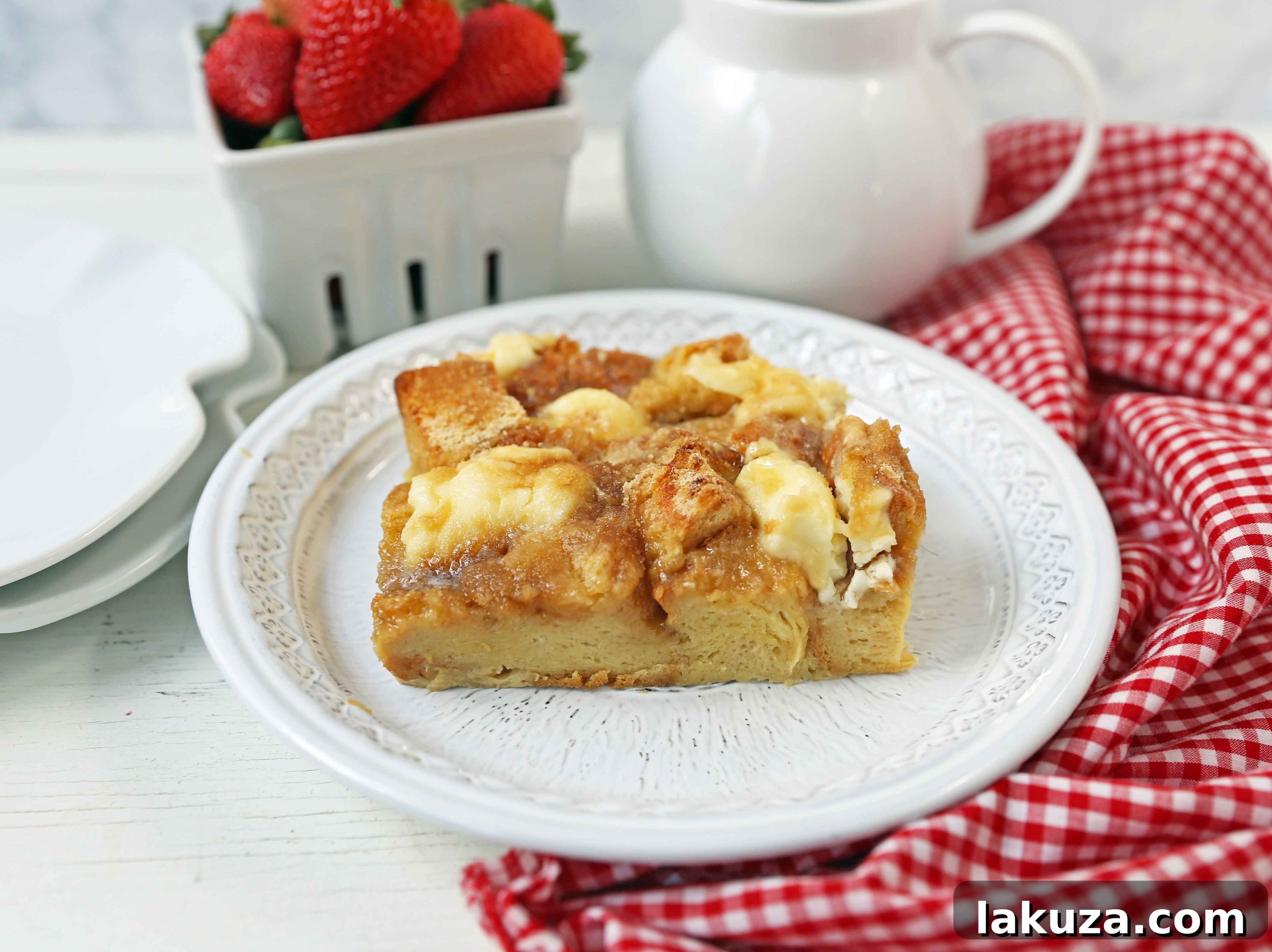 Brunch Bliss French Toast 5 Baked French Toast Casserole served with fresh strawberries, raspberries, and blackberries, generously drizzled with maple syrup.