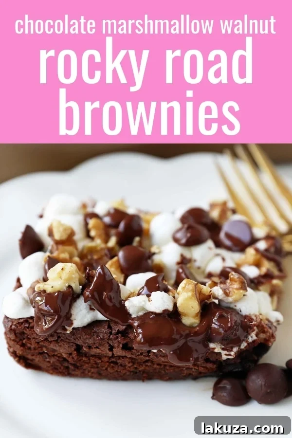 Stack of gooey Rocky Road Brownies on a white plate, ready to be enjoyed.