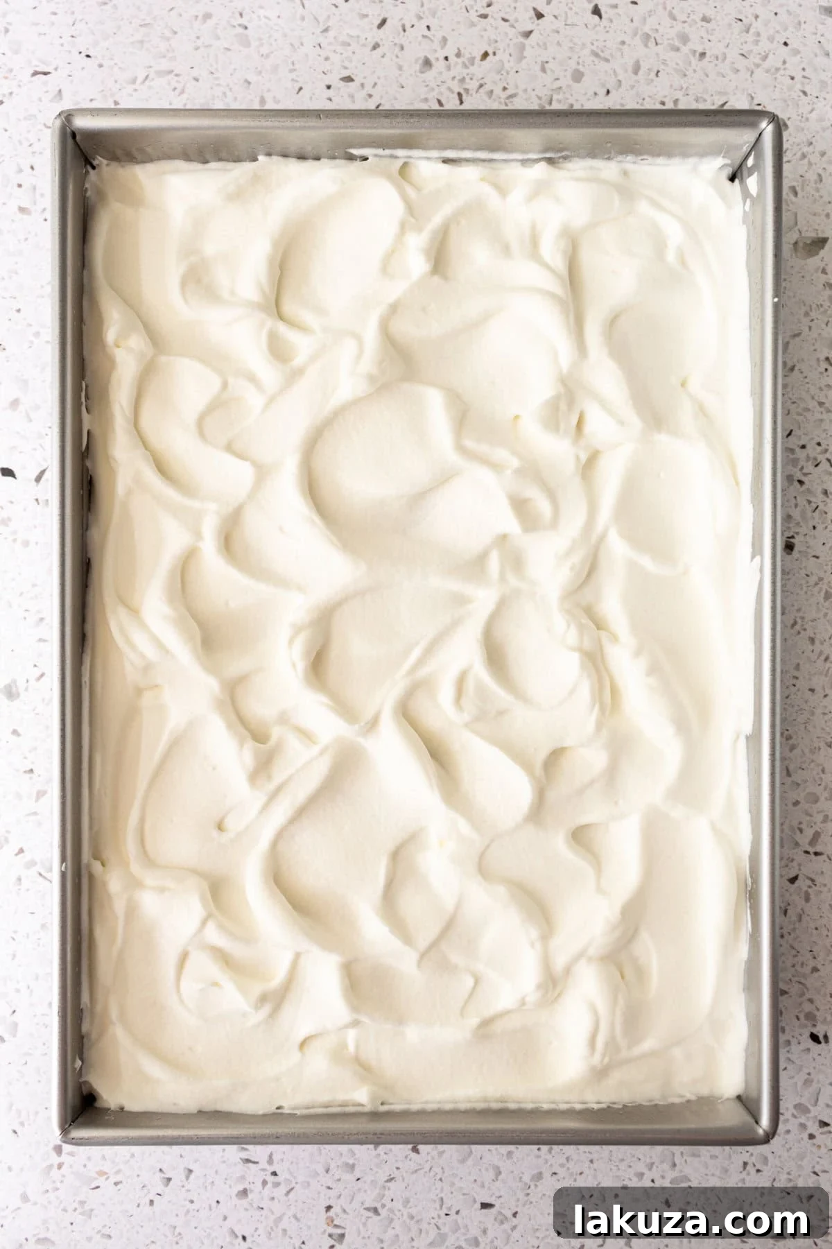 Tres Leches Cake with fresh homemade sweetened whipped cream on top.