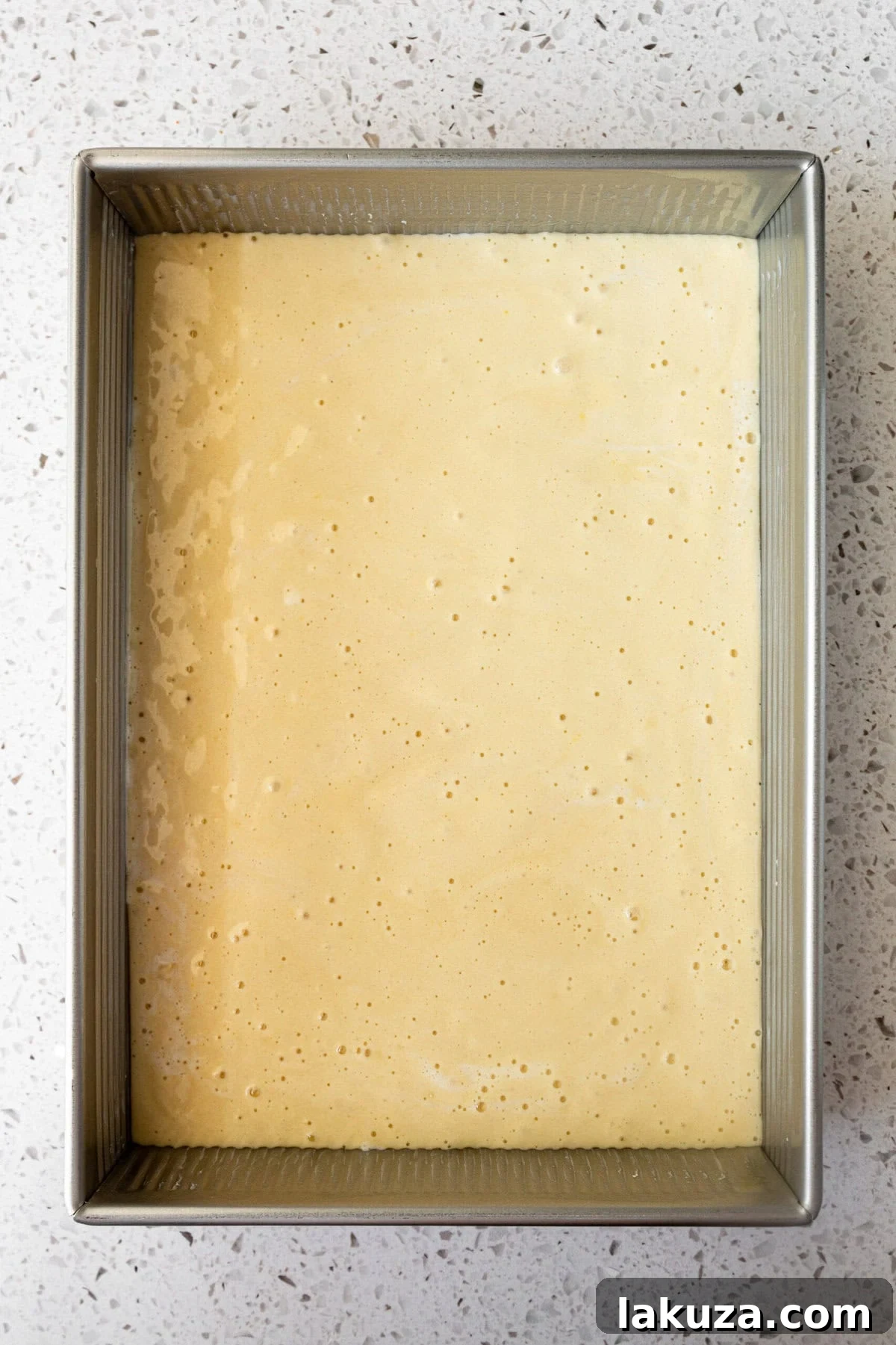 Homemade sponge cake in a 9 x 13 pan for tres leches cake