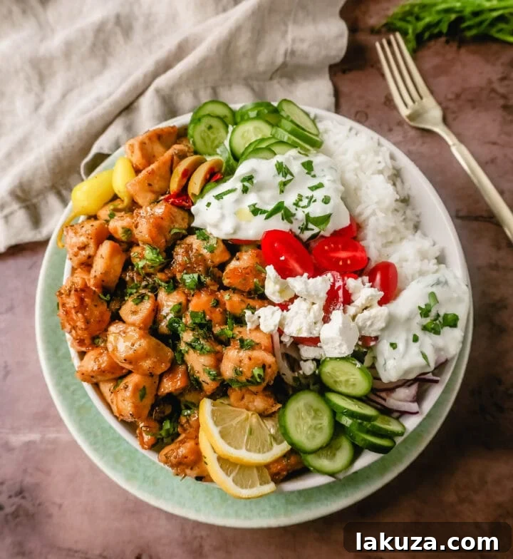 Grecian Harvest Bowls 2 Delicious Greek Chicken Bowl with grilled lemon chicken, fresh vegetables, feta, olives, and homemade tzatziki sauce. A healthy and vibrant meal.